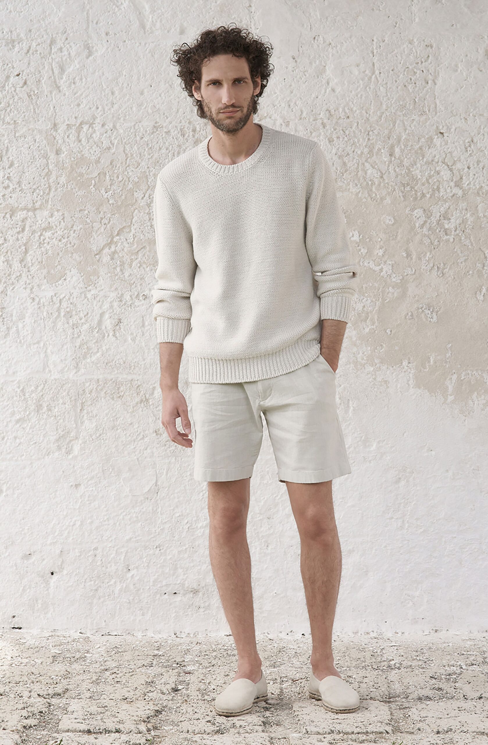 white relaxed sweater with beige shorts