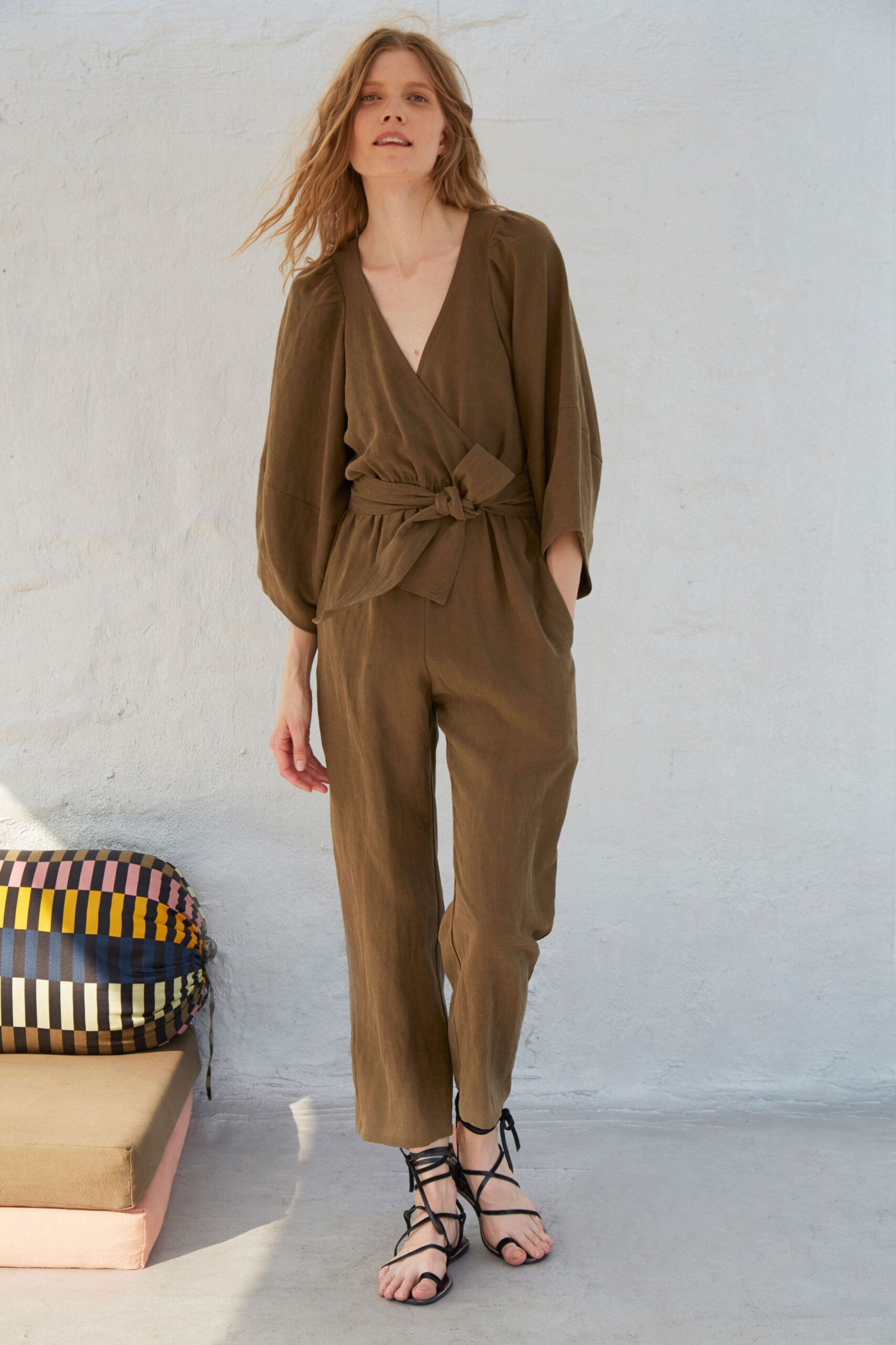 brown relaxed jumpsuit with strappy shoes