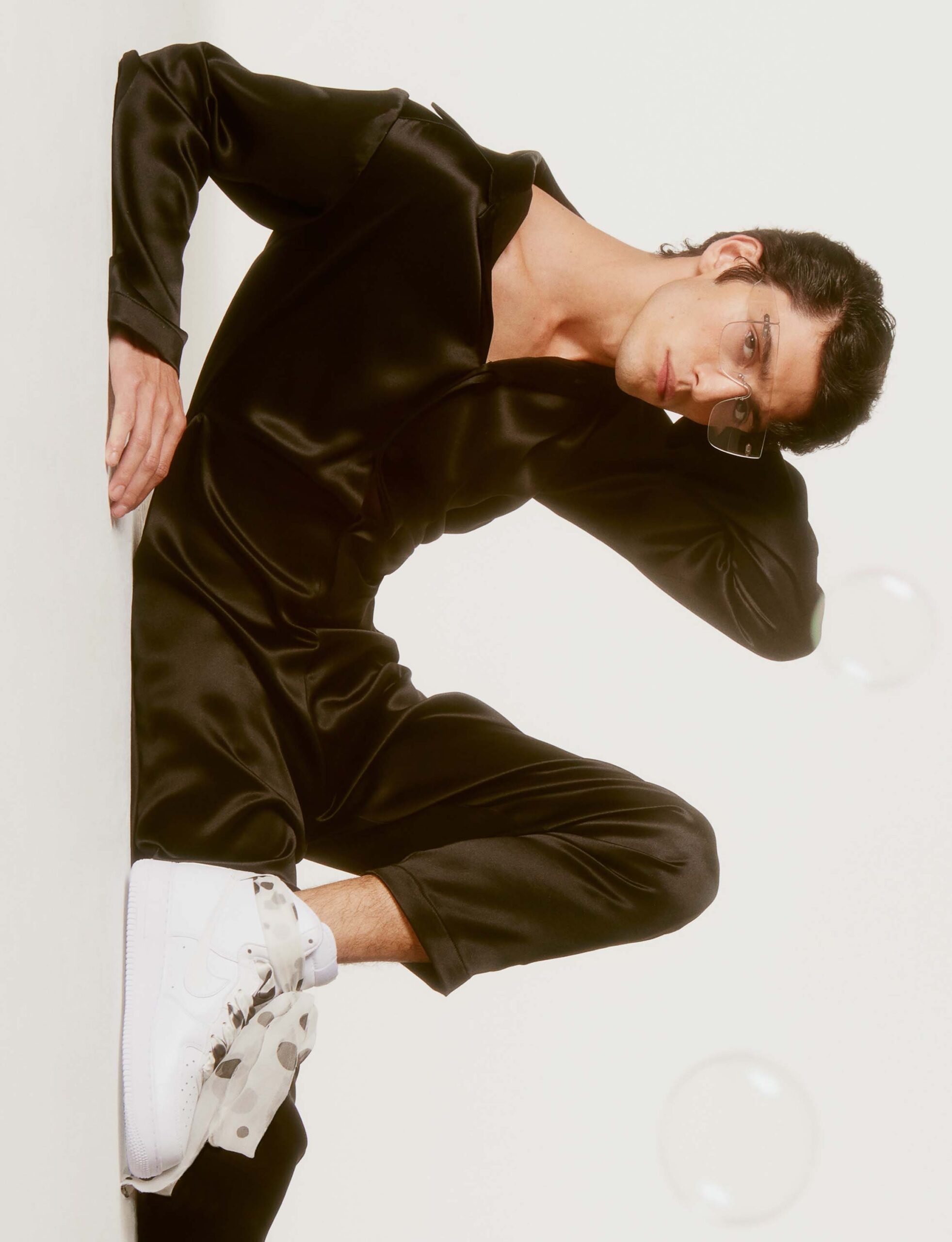 black silk fitted jumpsuit with white shoes