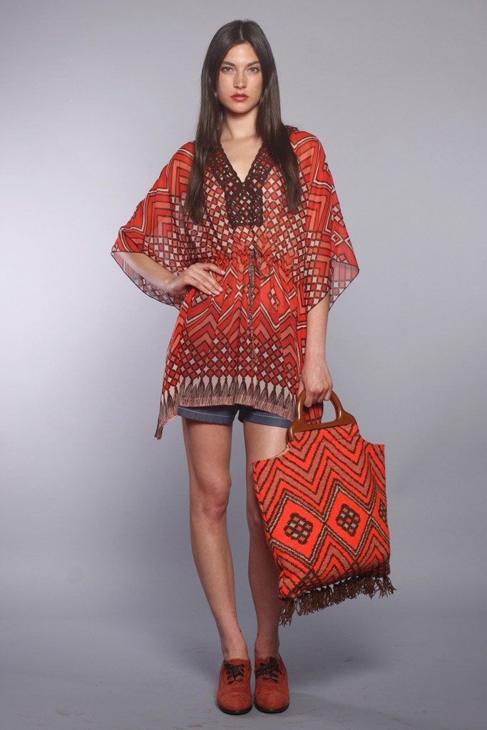 red printed top with denim shorts