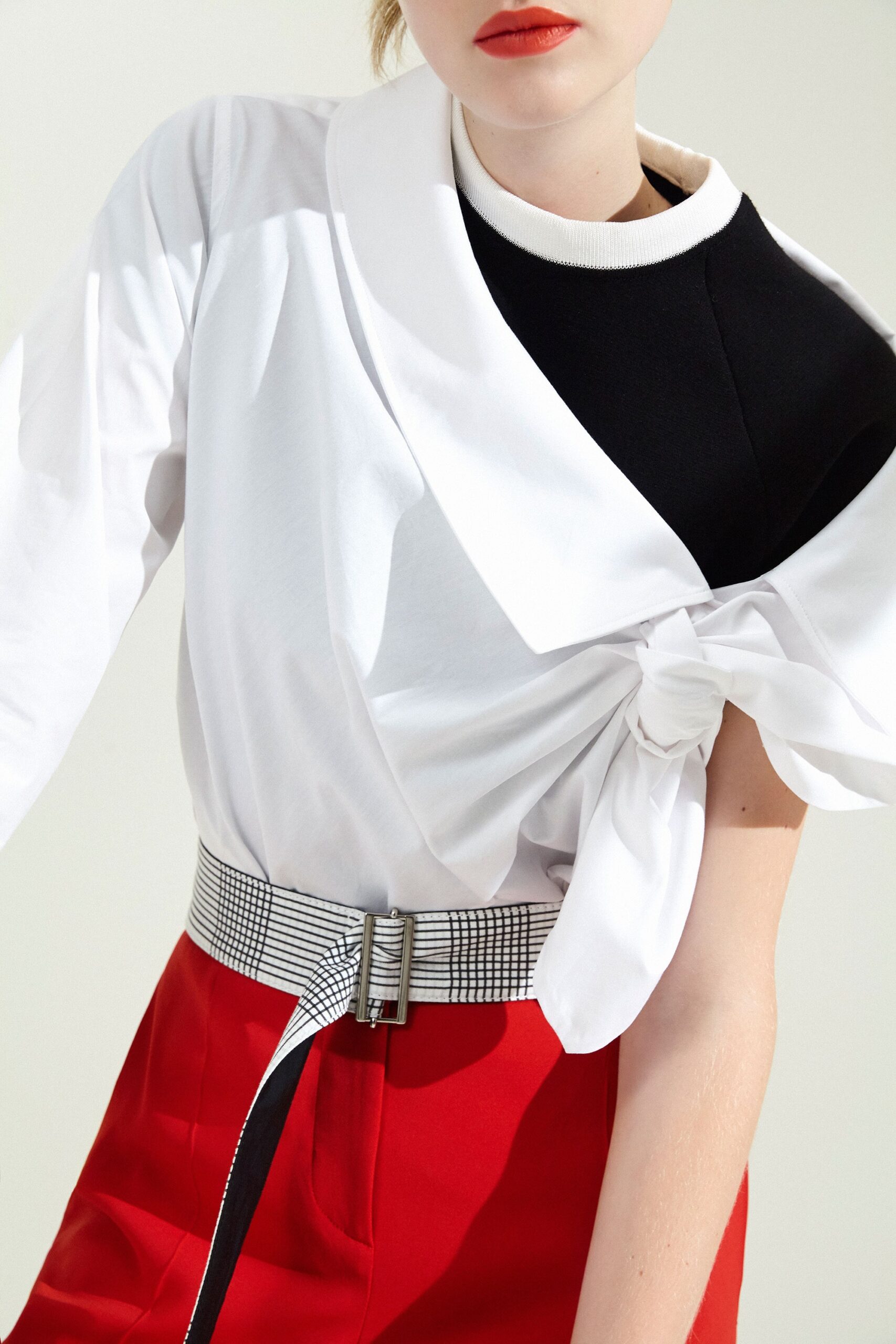 asymmetric black and white top with red pants
