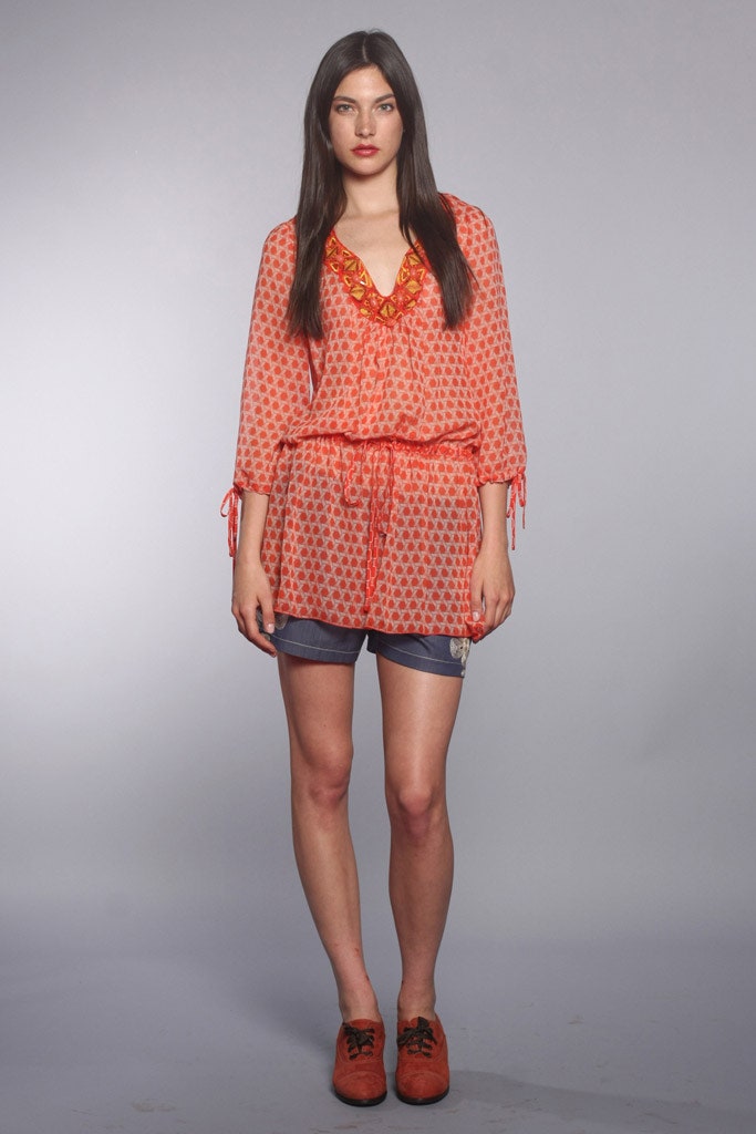 orange printed blouse with denim shorts