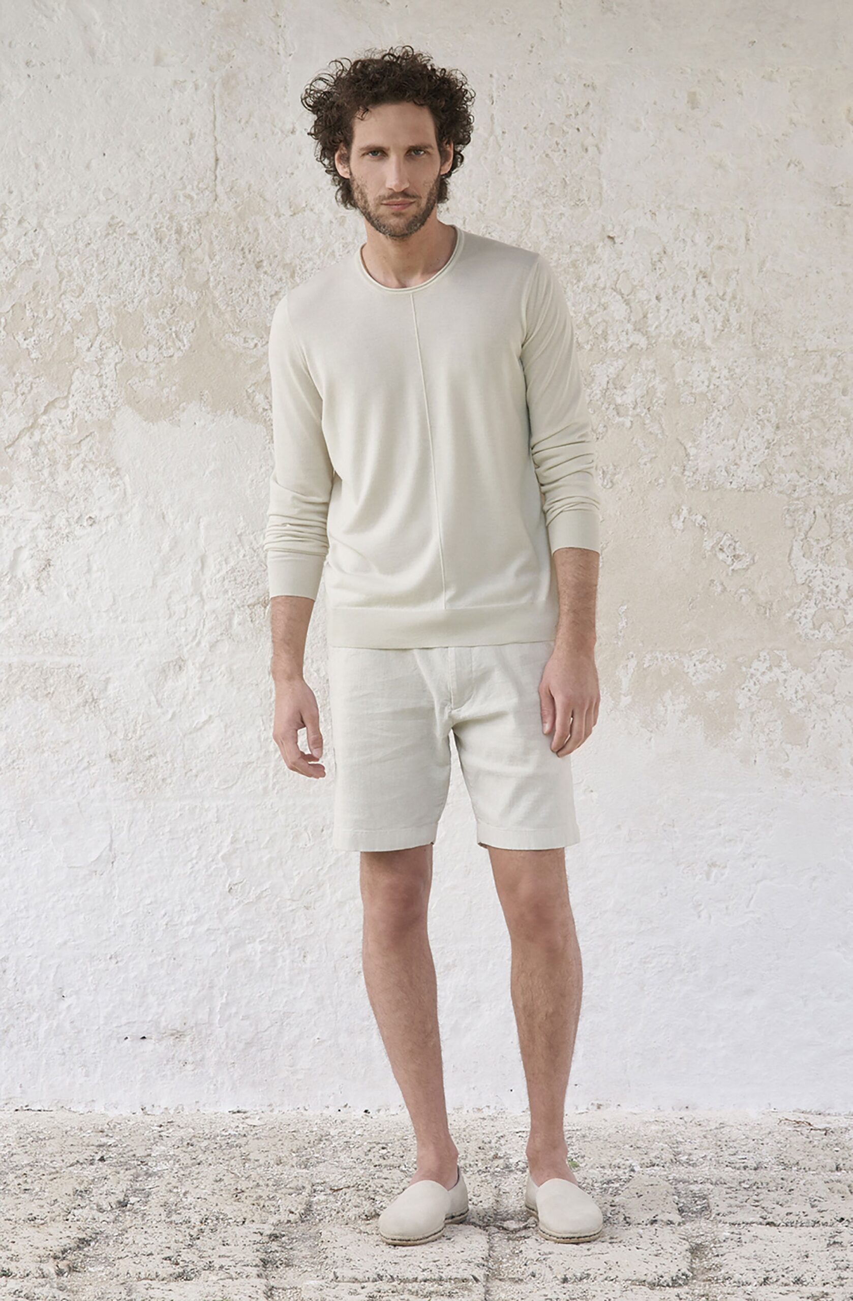 white fitted sweater with beige shorts