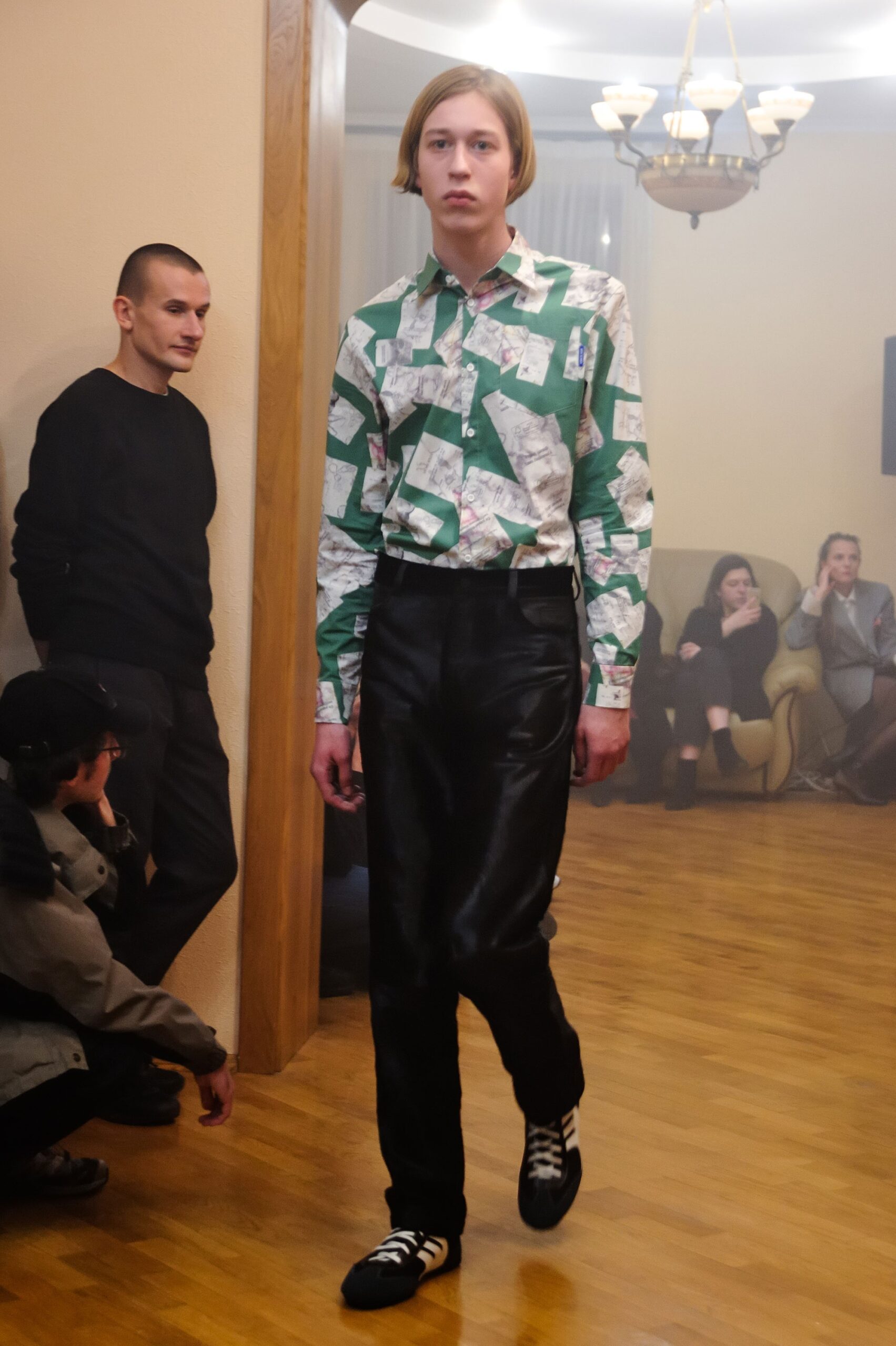 green printed shirt with black leather pants