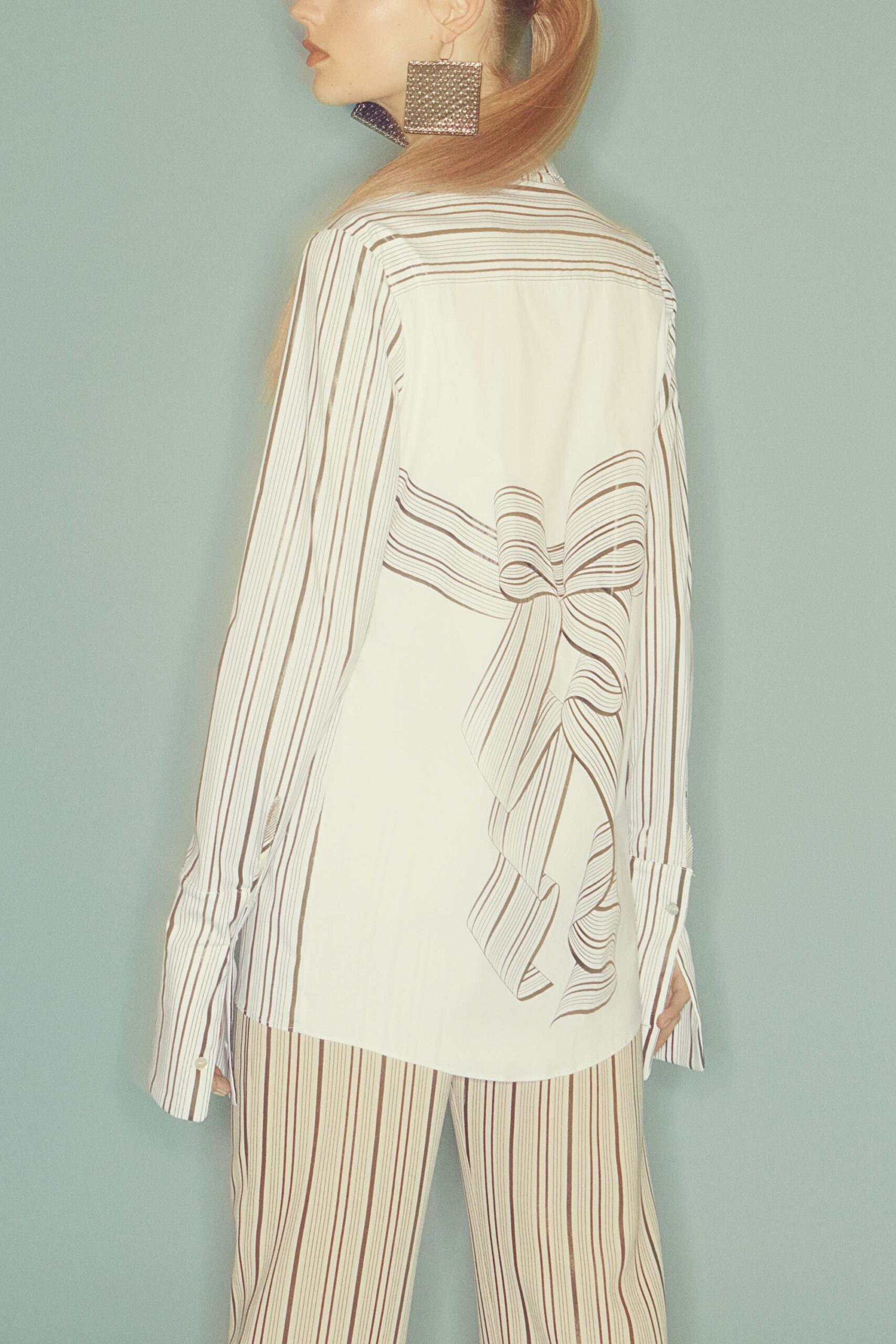 striped white shirt with beige pants