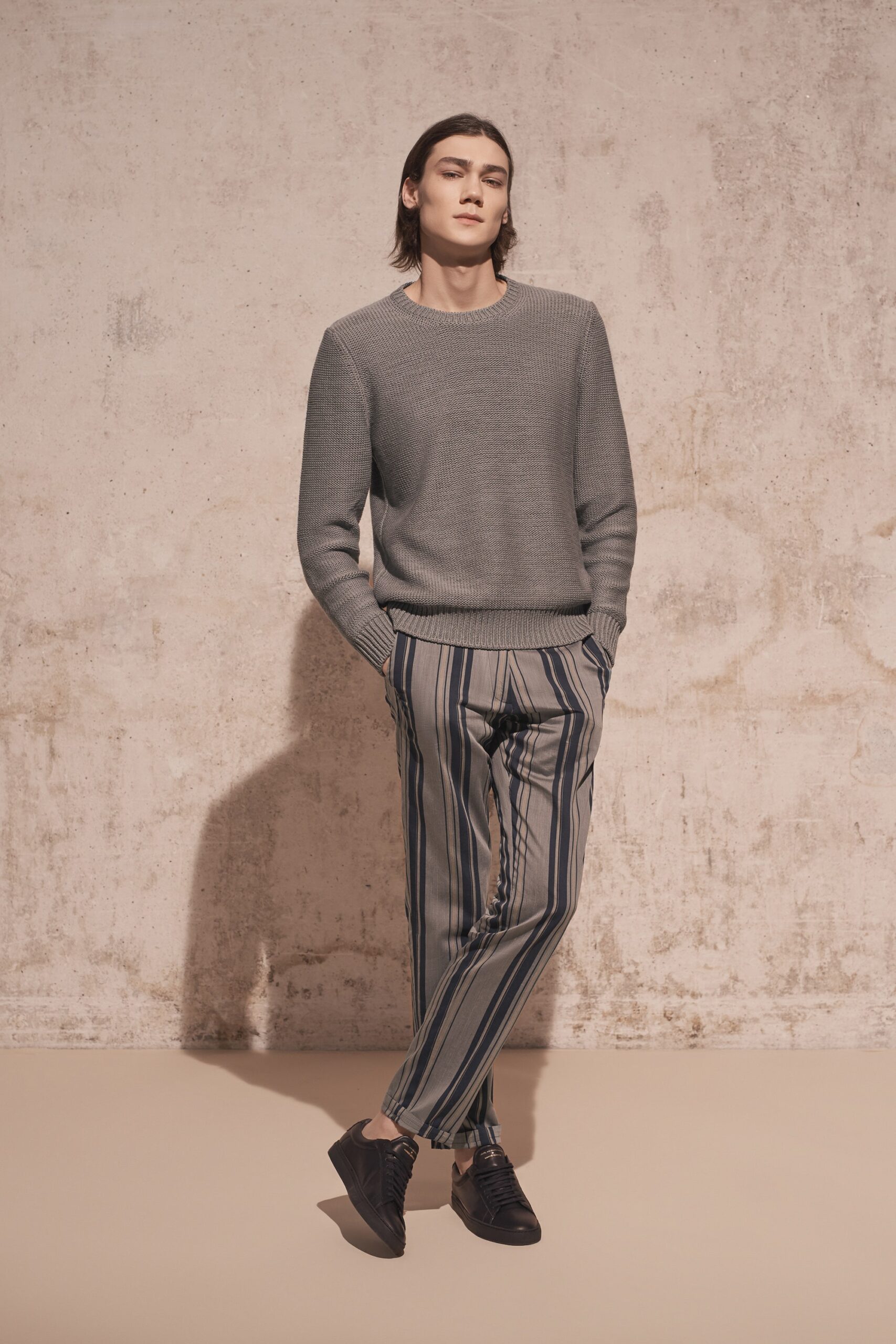 gray fitted sweater with striped pants