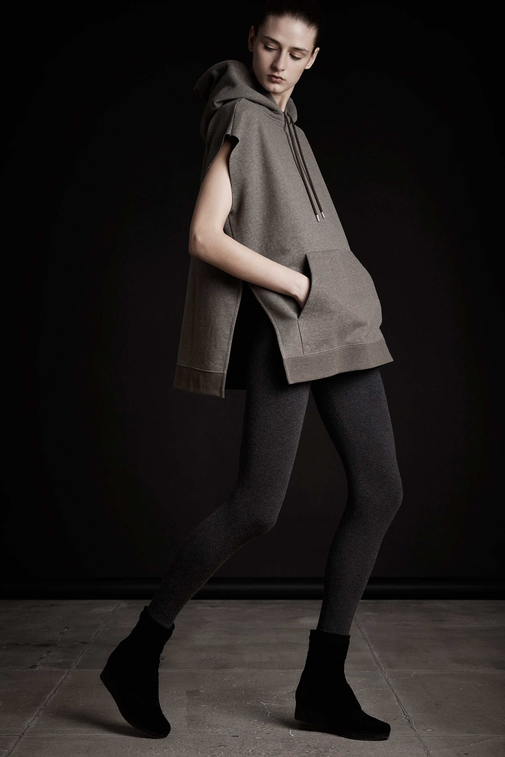 gray sleeveless hoodie and black leggings