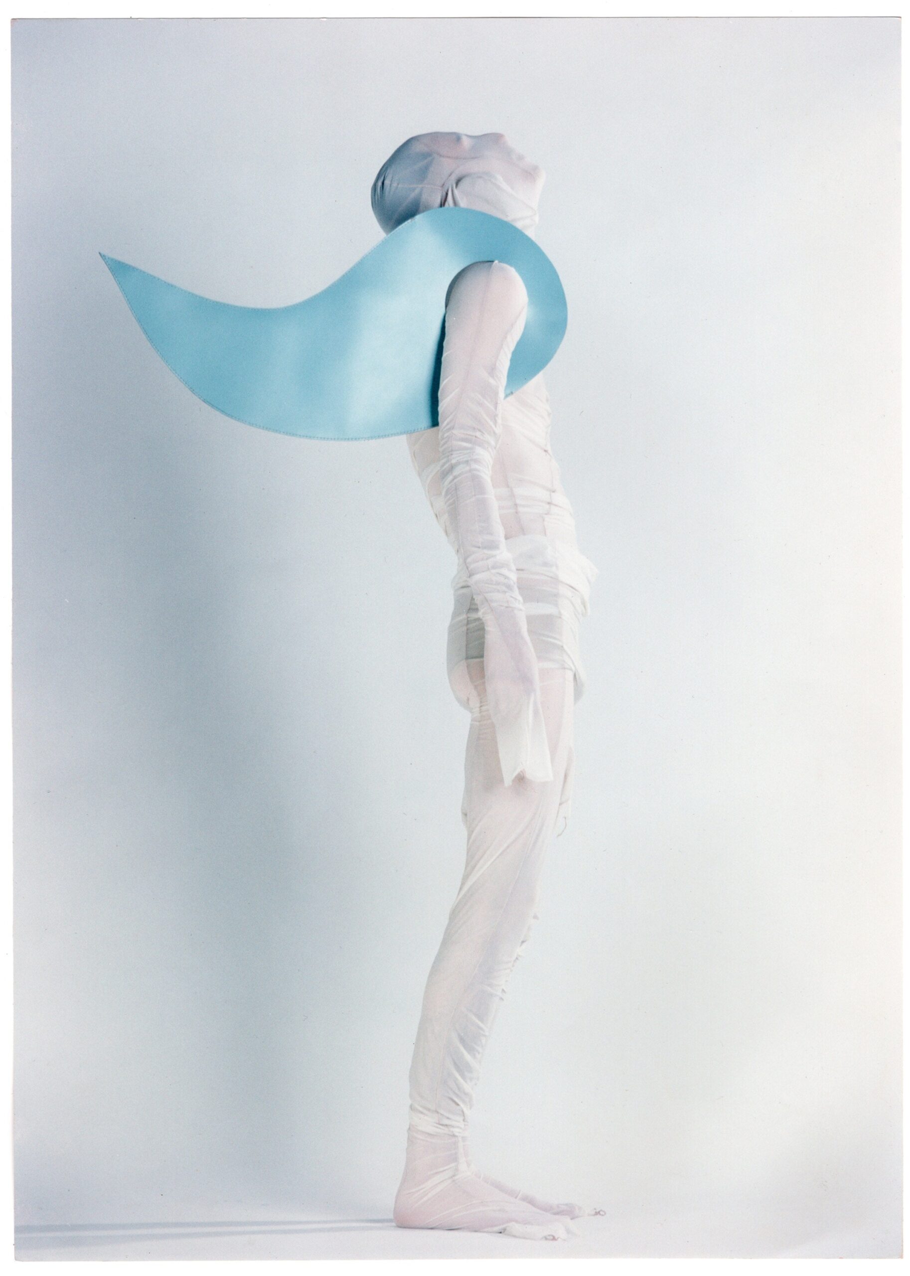 blue vinyl cape and white mesh bodysuit