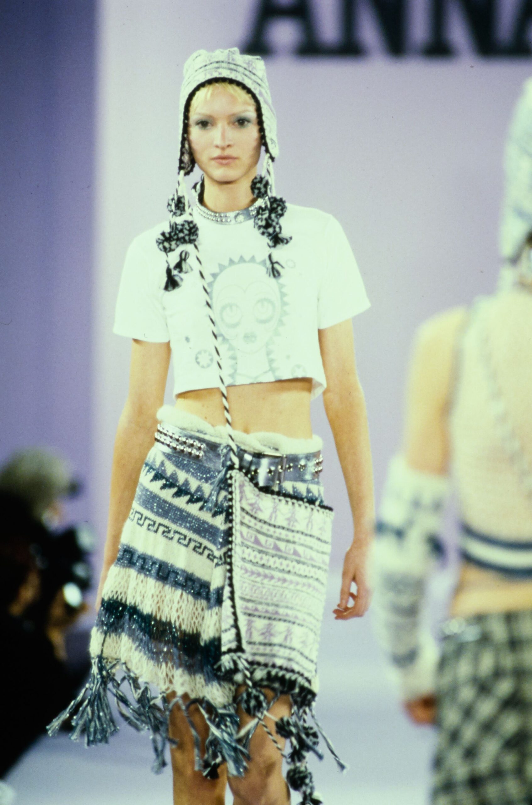white crop-top with blue fringed skirt