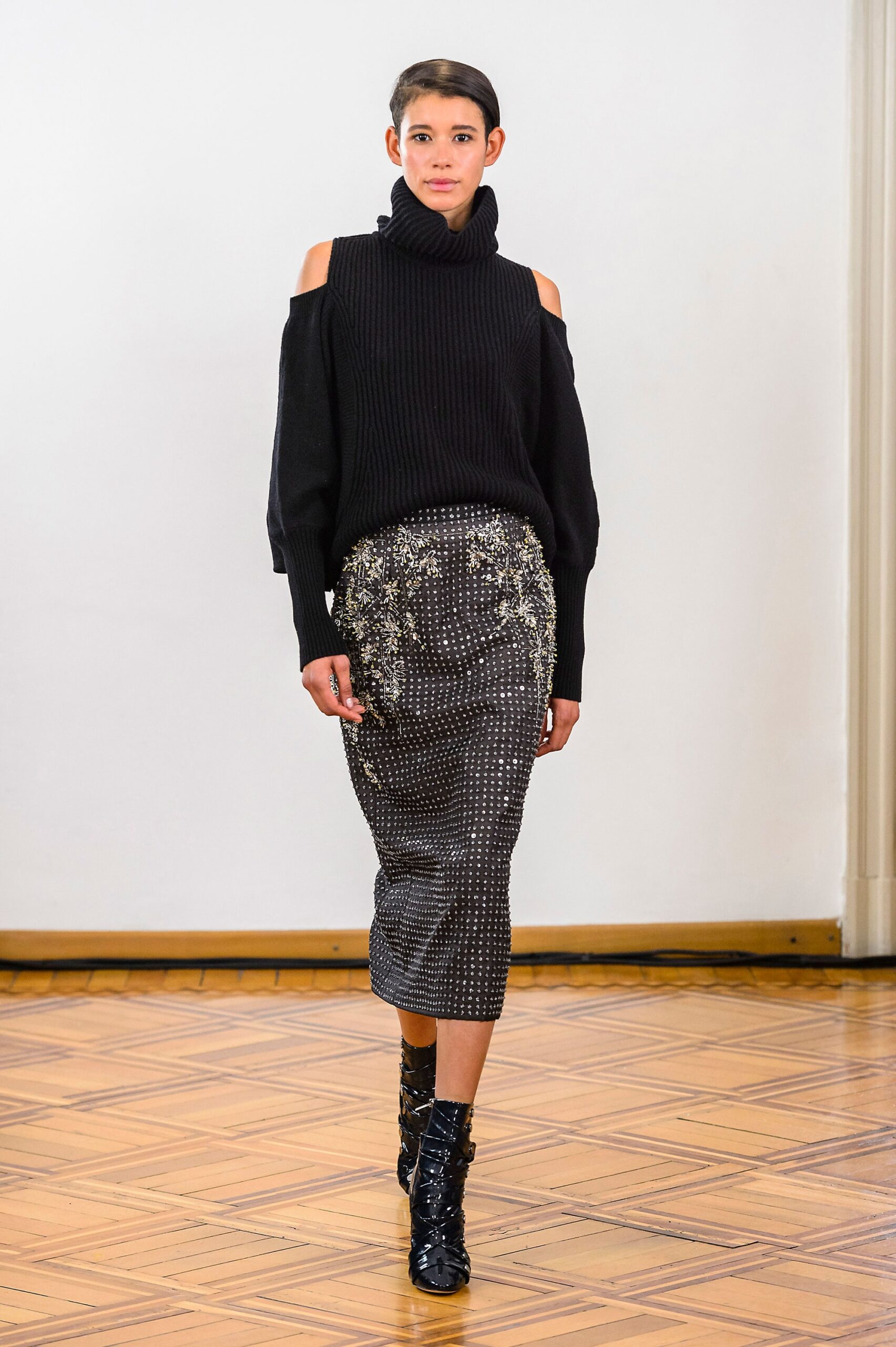 black wool off-shoulder sweater and gray midi skirt