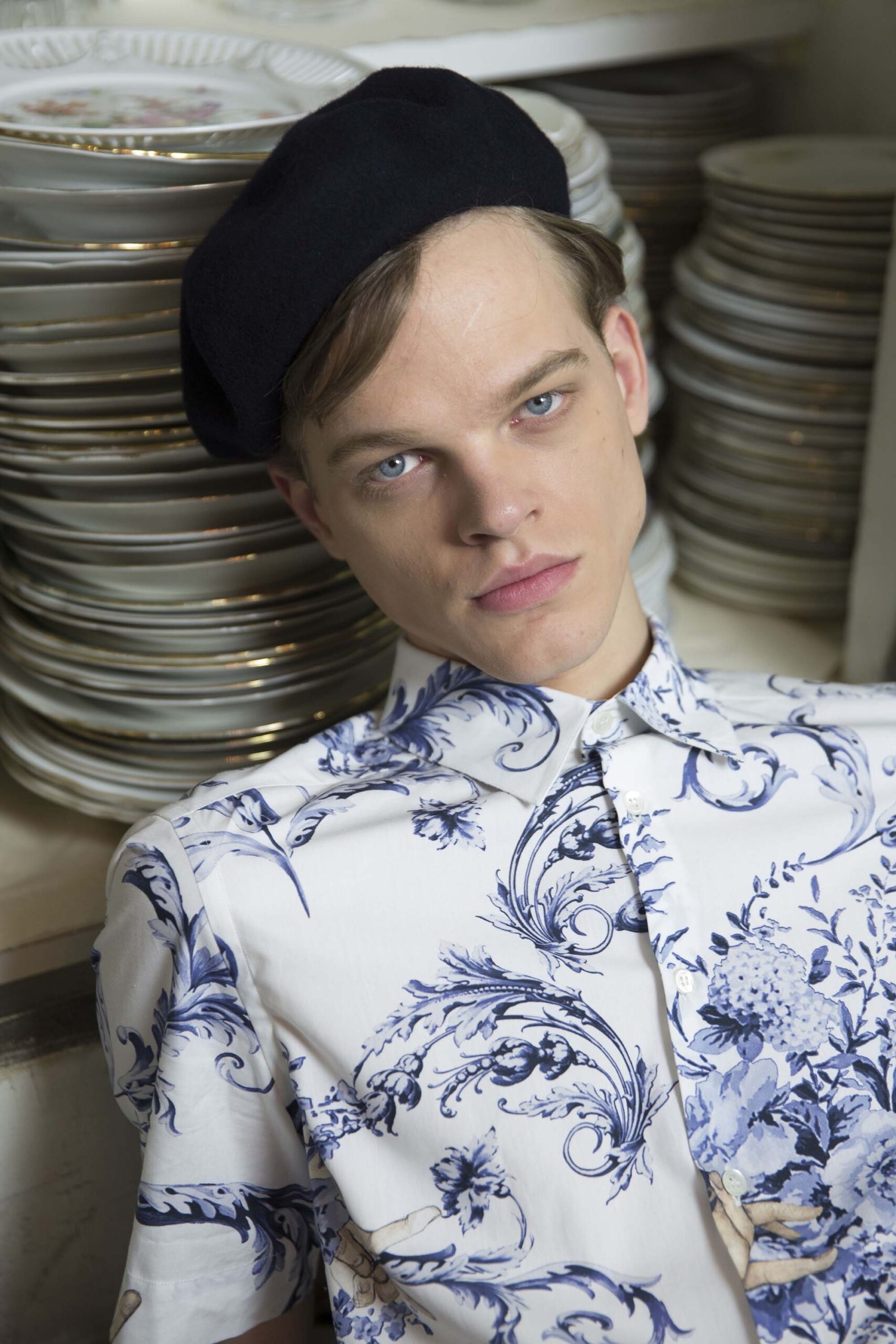 fitted blue and white printed shirt with black hat