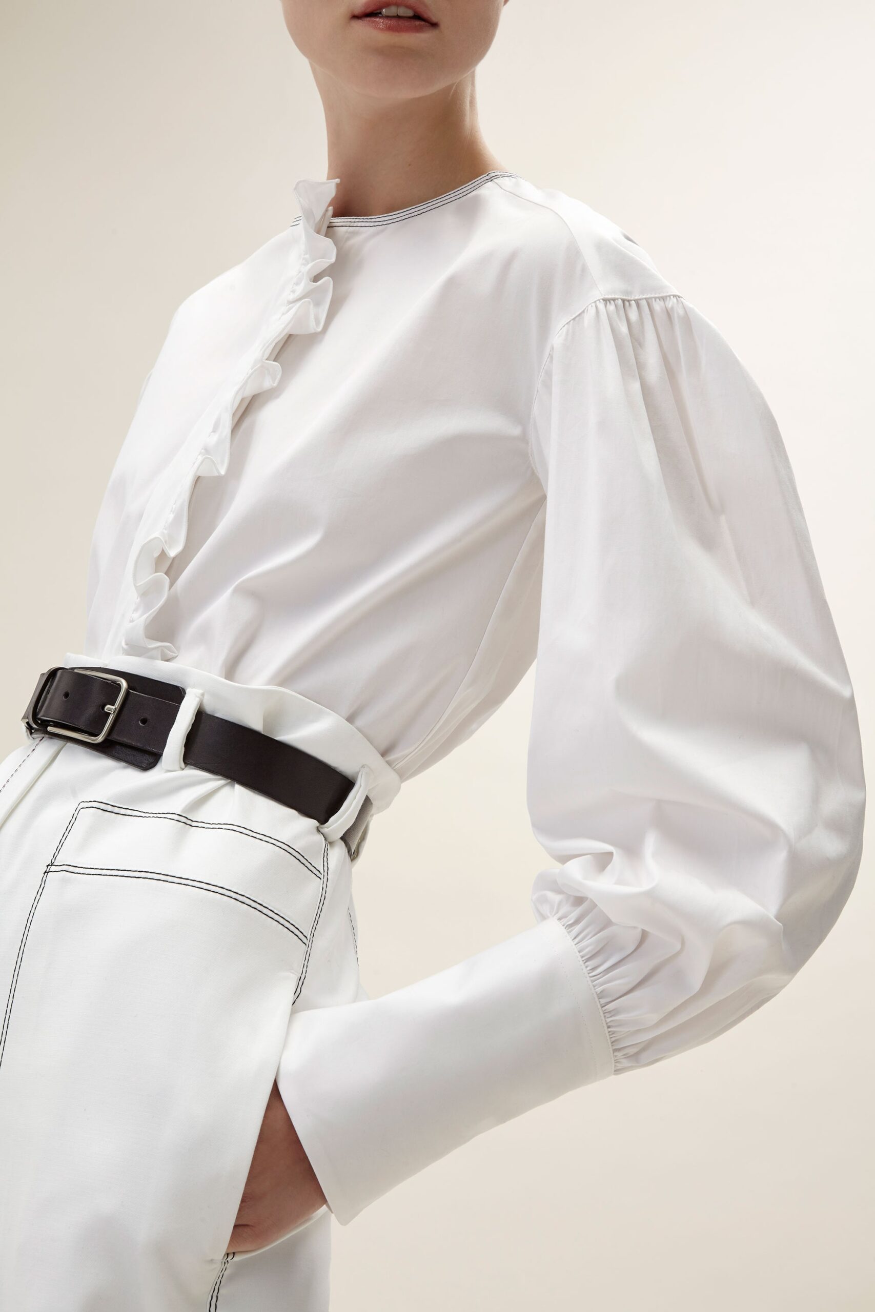 white fitted blouse with relaxed pants