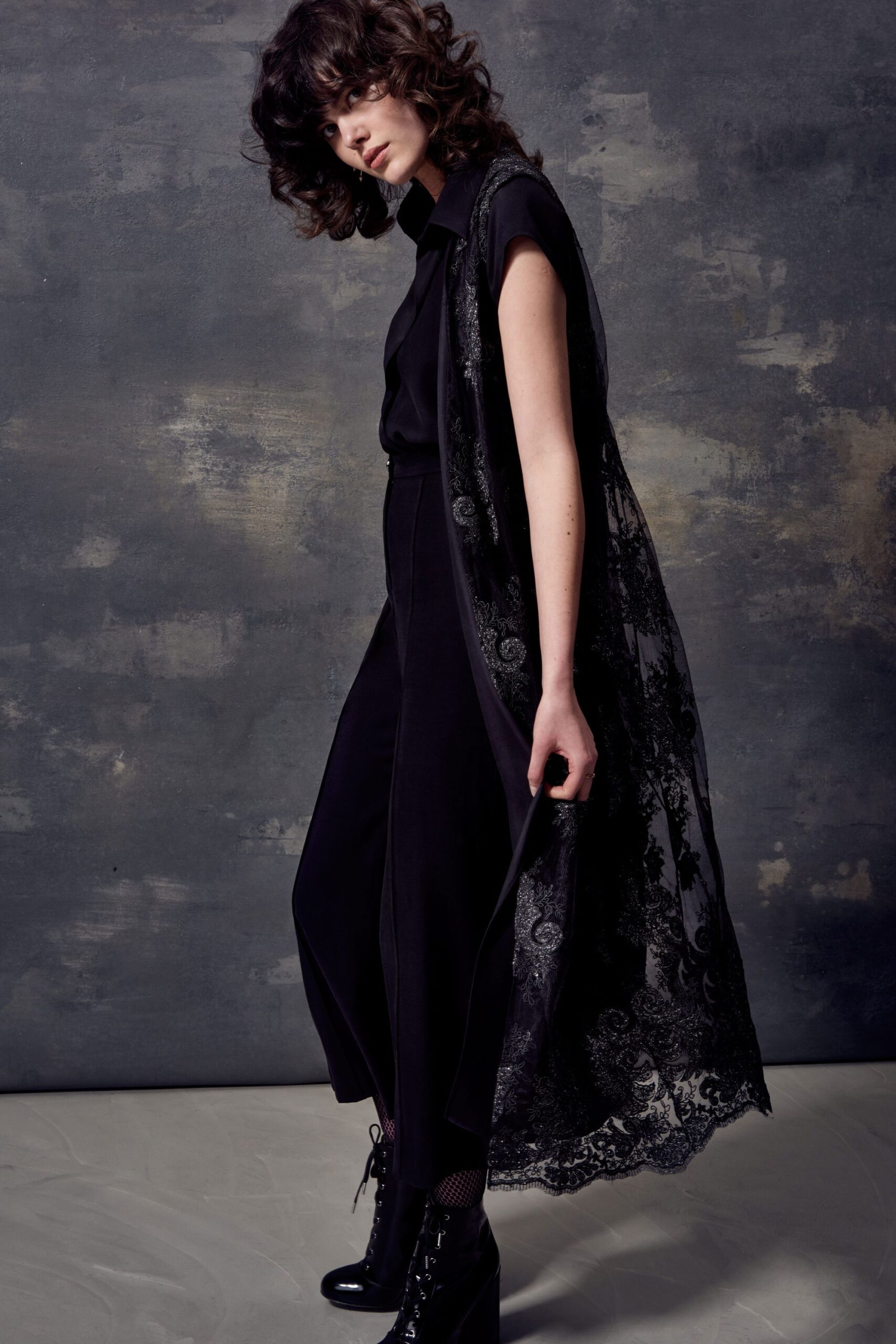 black fitted jumpsuit with lace cape