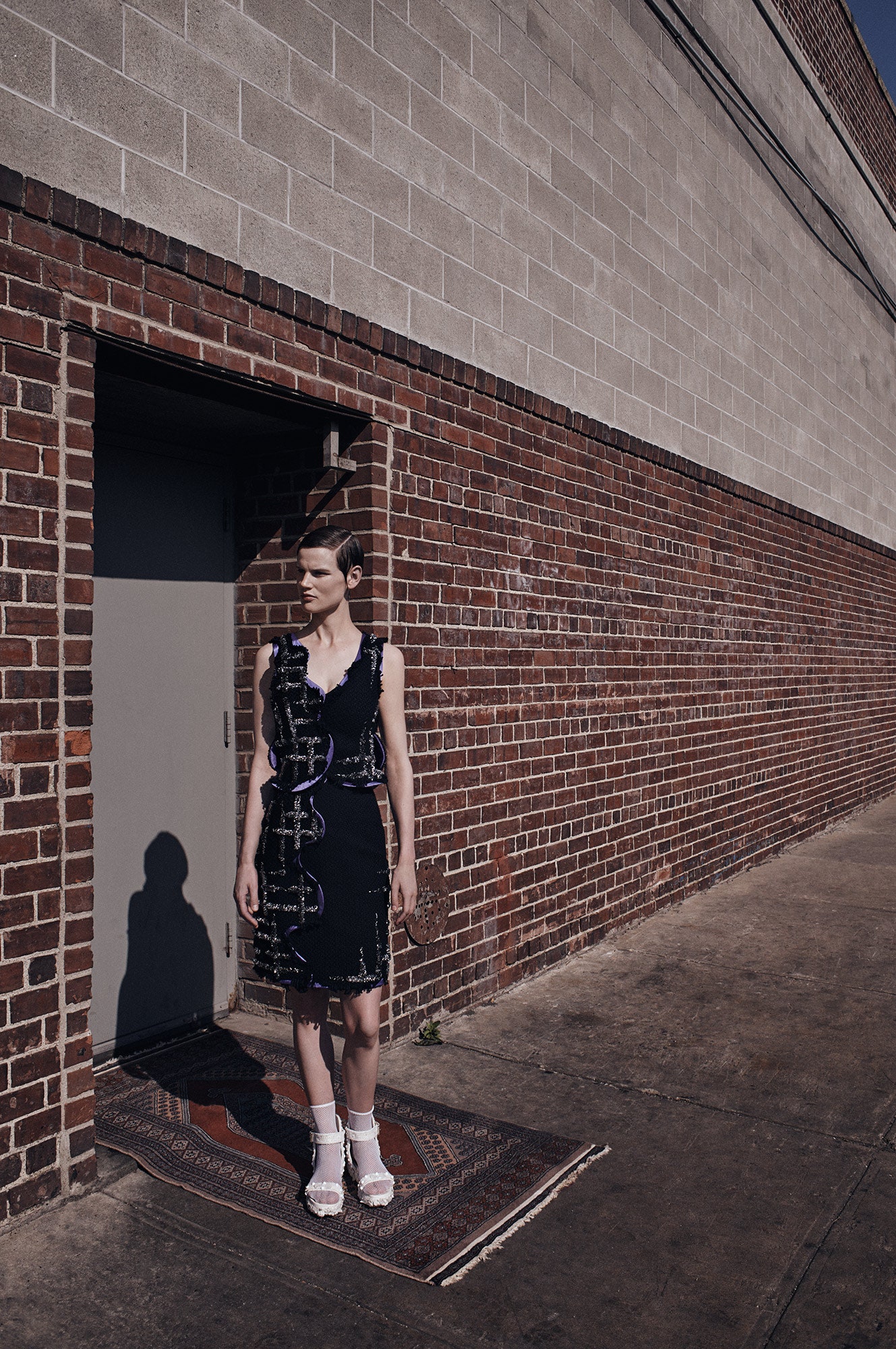 fitted black sleeveless dress