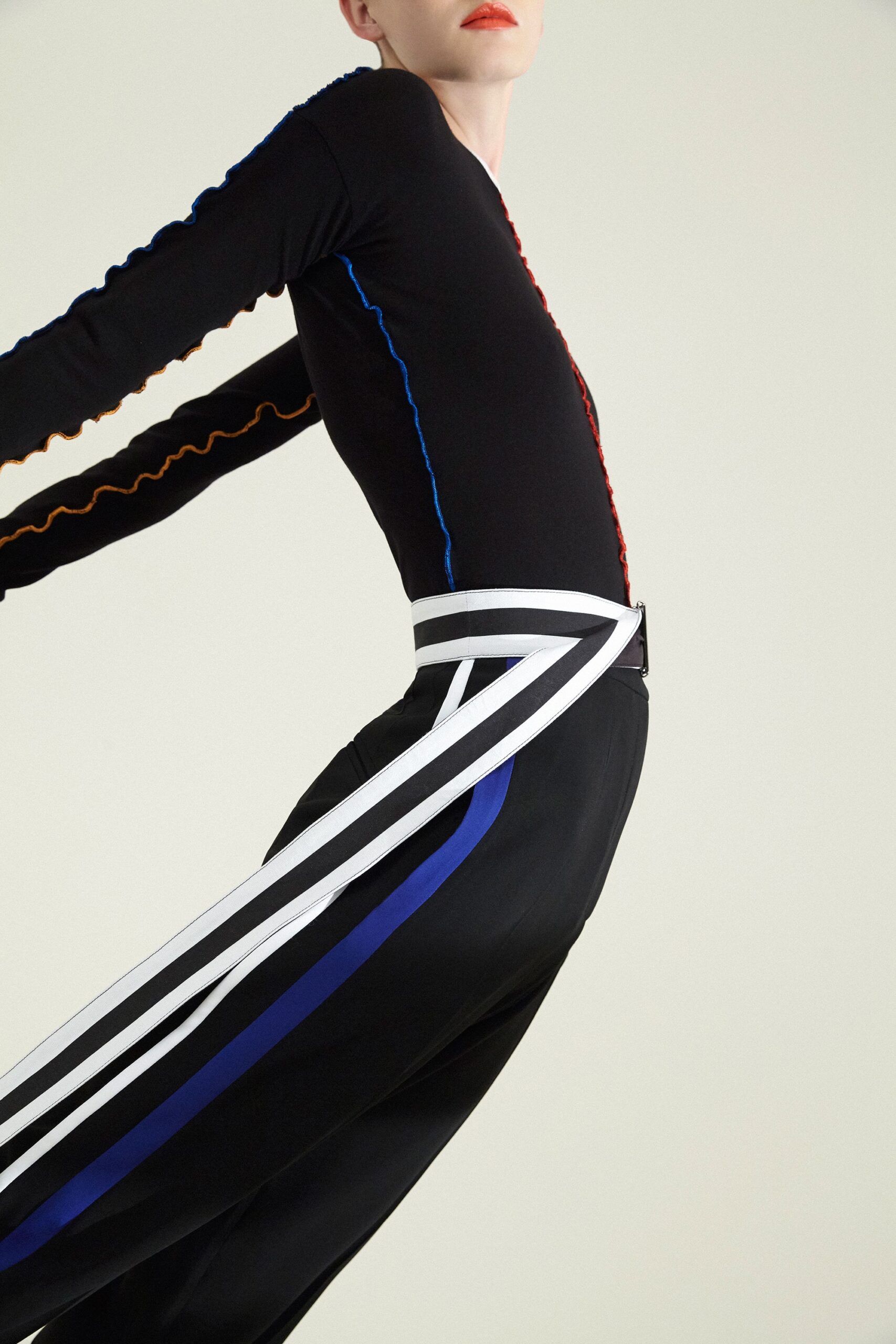 black fitted top with striped pants