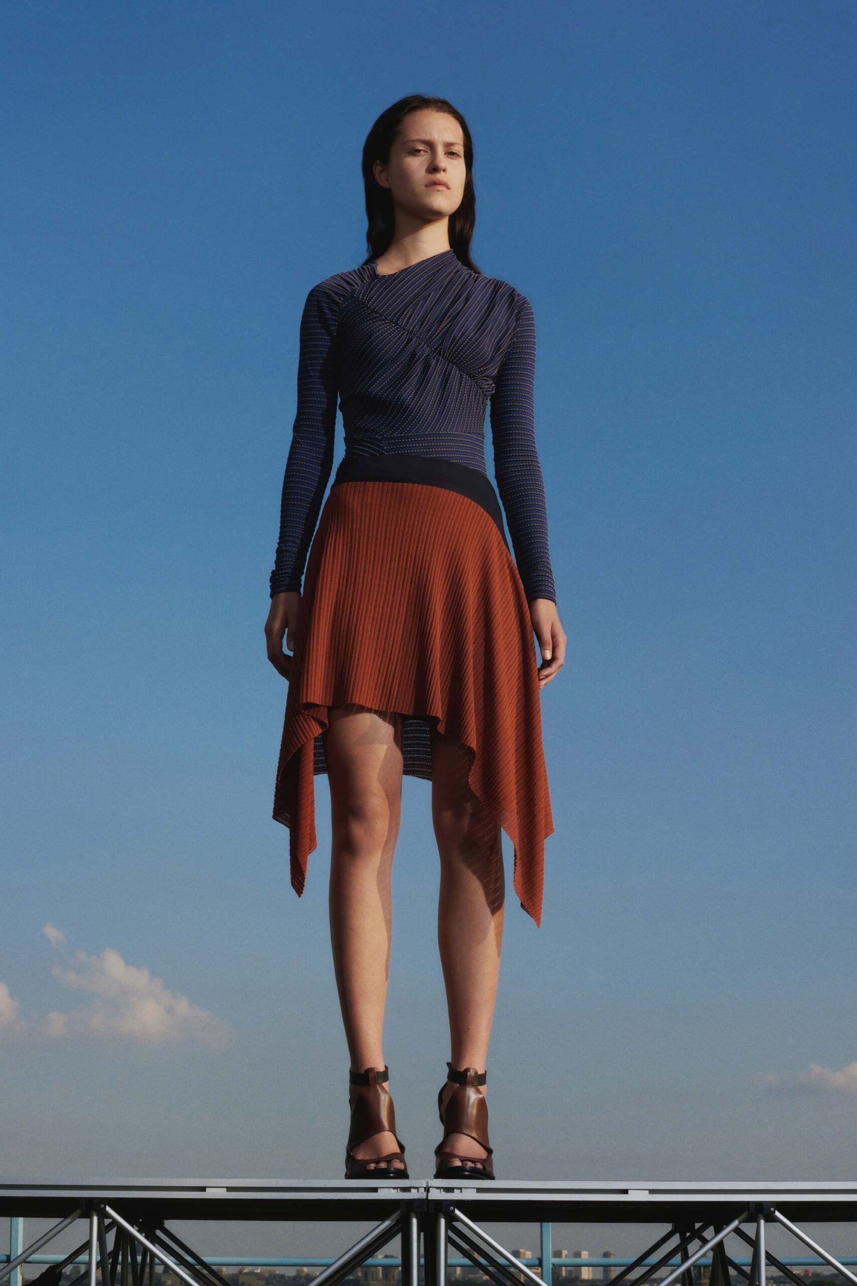 blue fitted top with asymmetric orange skirt