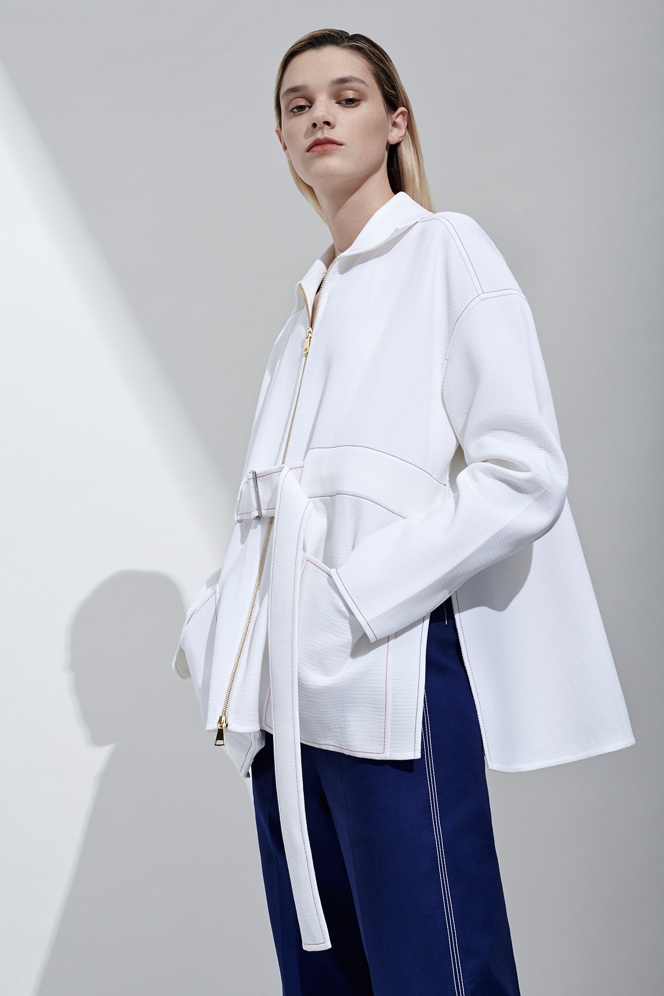 white relaxed jacket with blue pants