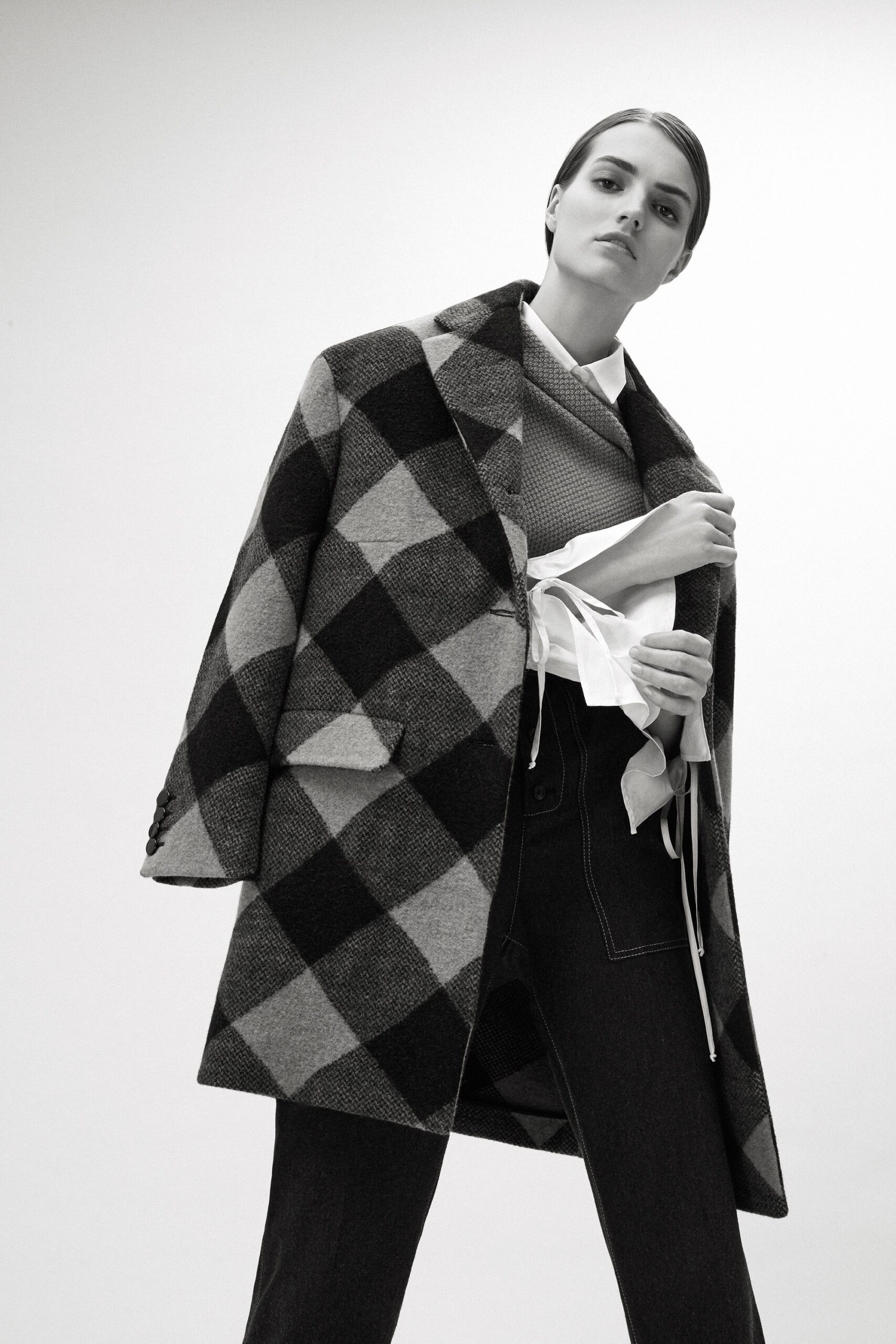 checked wool coat with fitted sweater