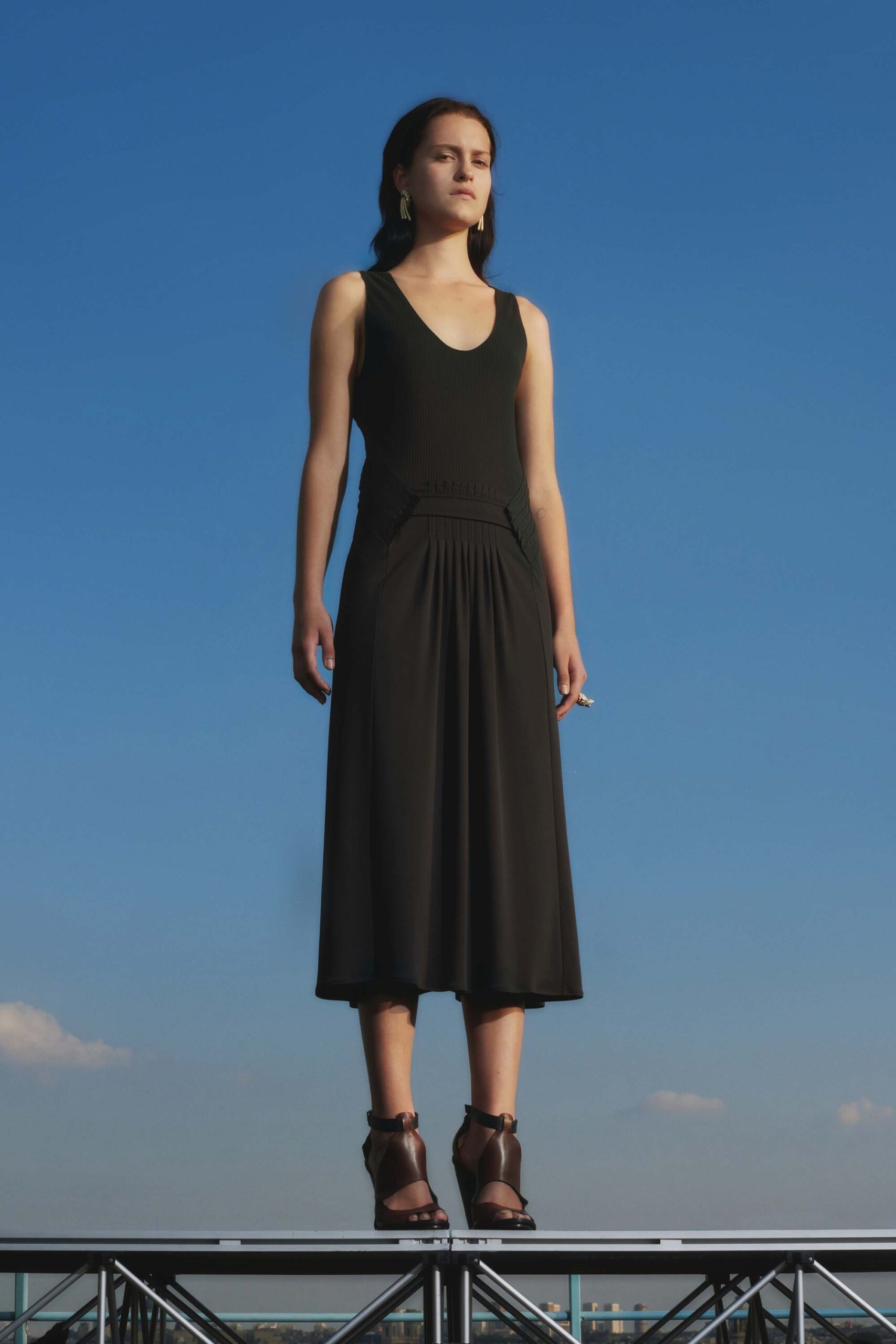 black fitted midi dress with brown shoes
