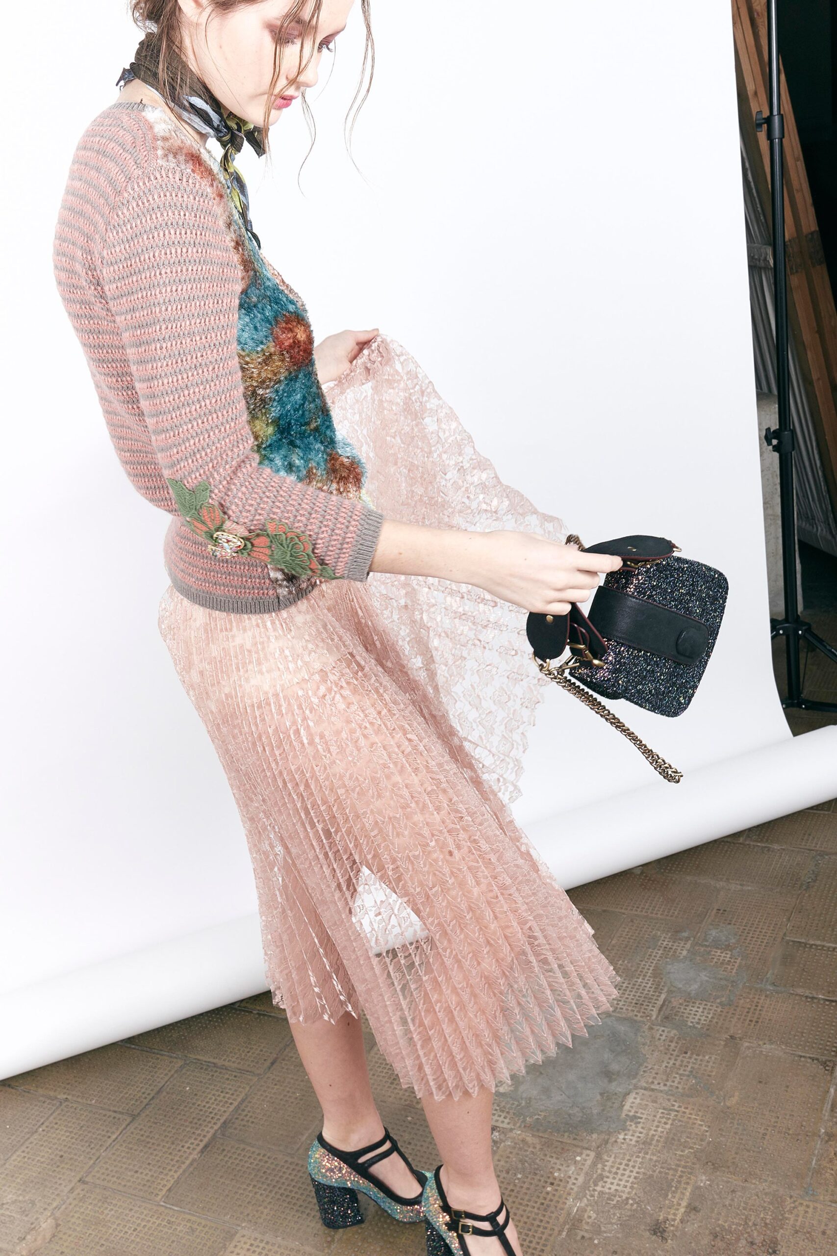 pink fitted sweater and pleated skirt