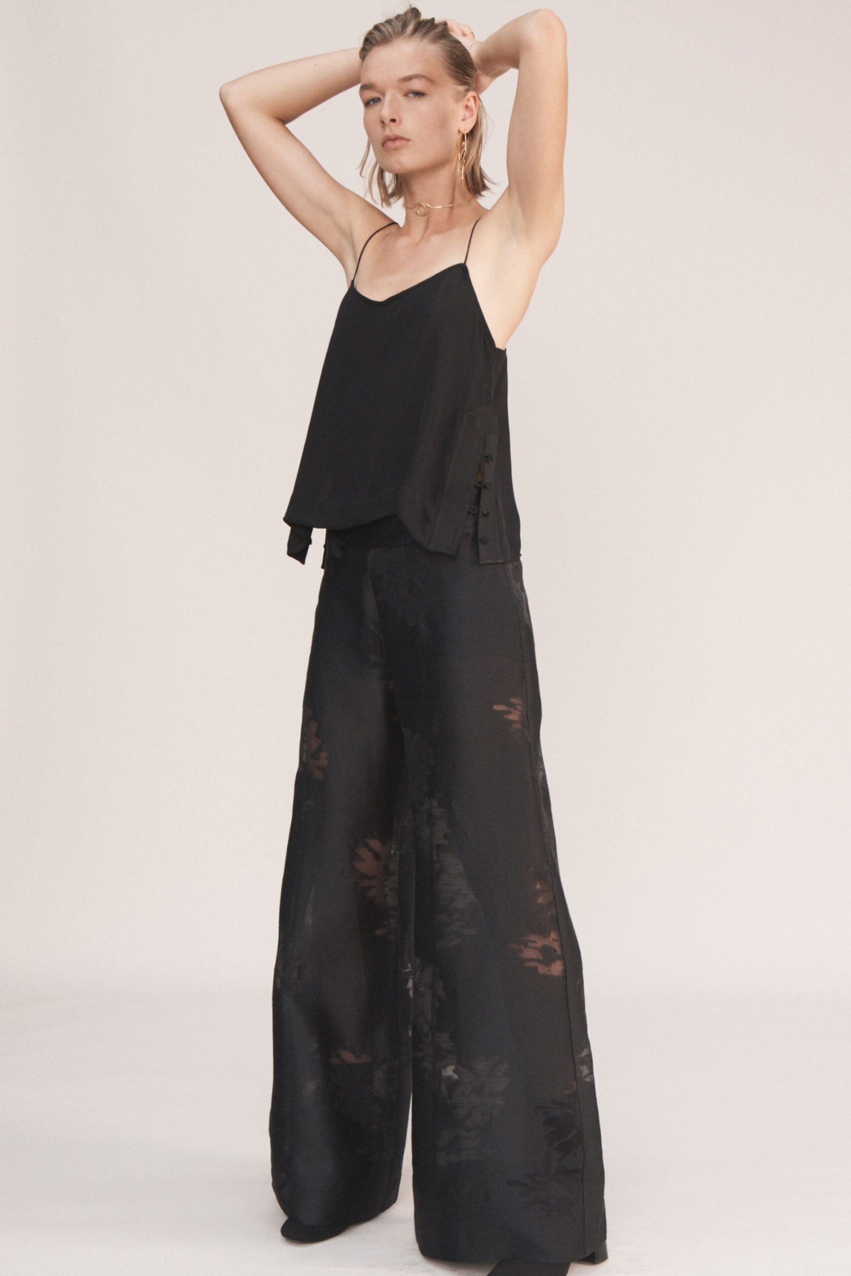 black silk sleeveless top and wide-leg pants