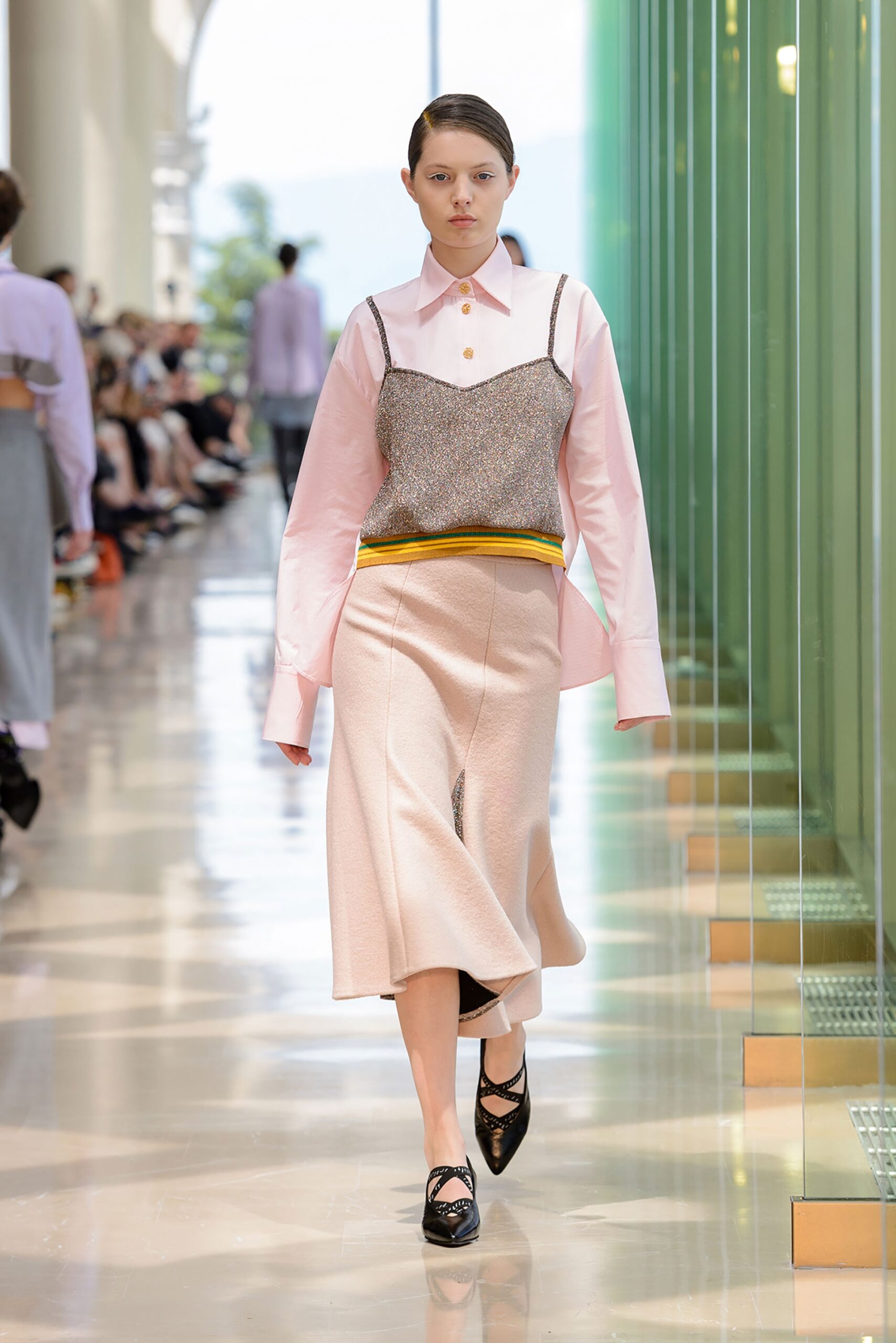 pink shirt gray vest beige skirt