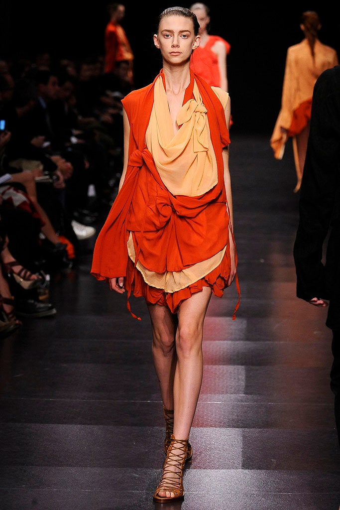 orange draped mini dress with strappy shoes