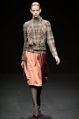 brown checked blazer and orange pleated skirt
