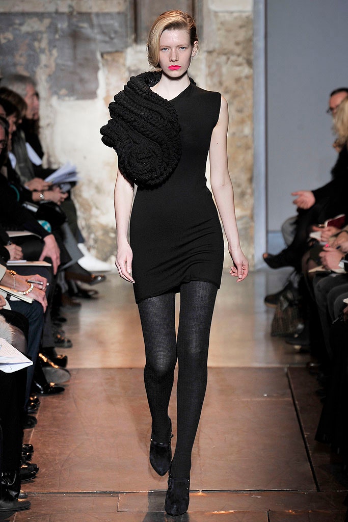 black fitted mini dress with layered accessory