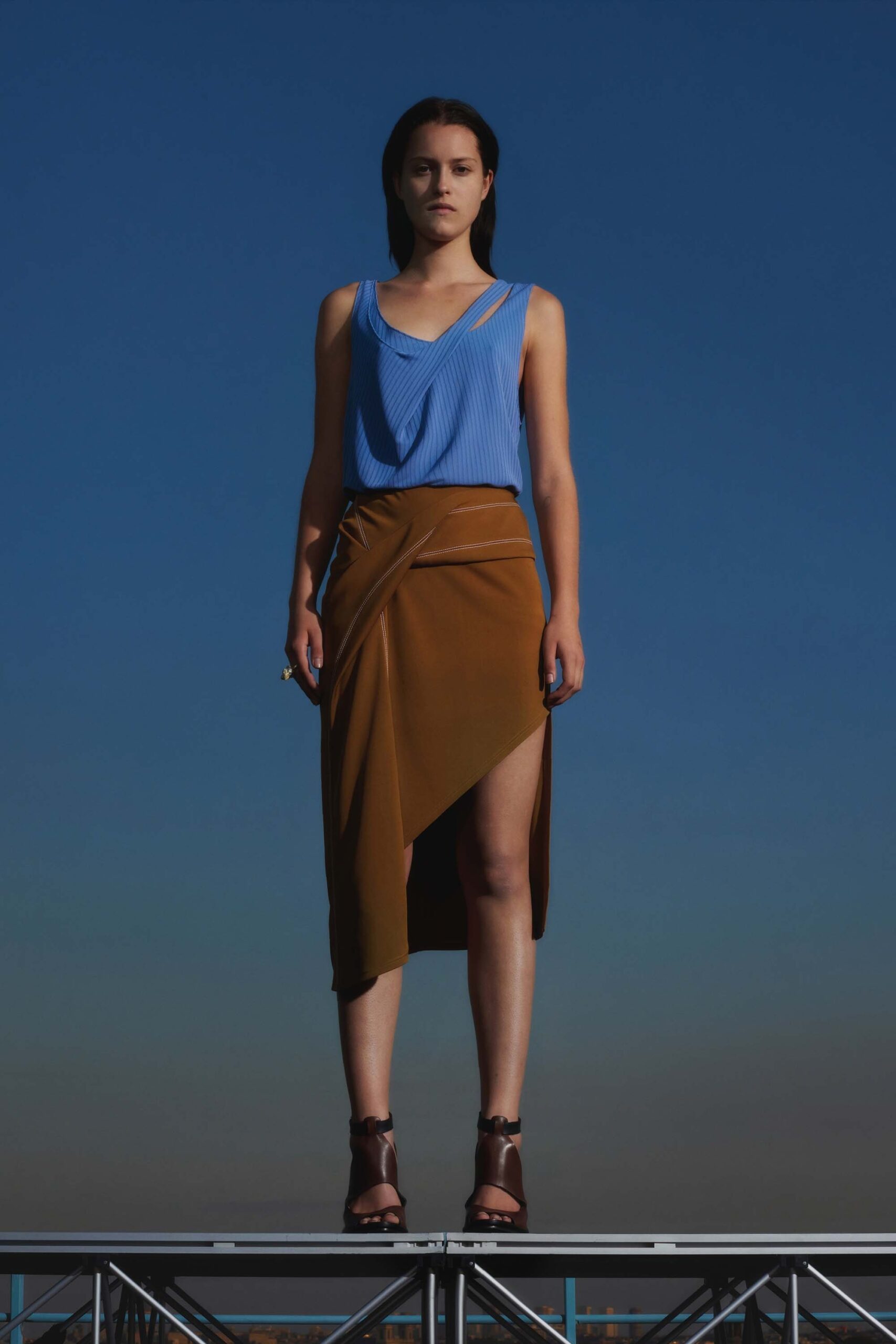 blue fitted top with brown asymmetric skirt