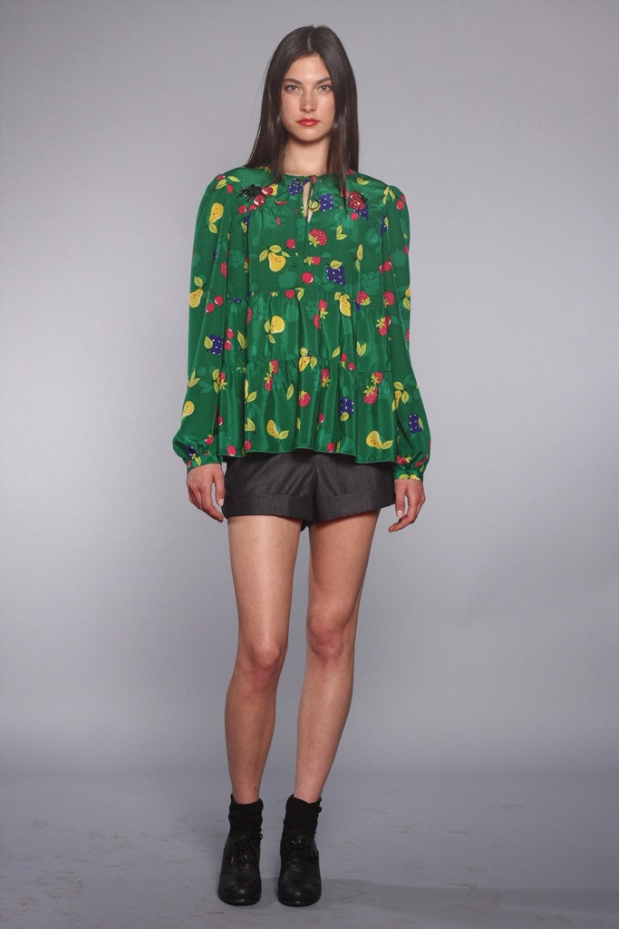 green printed blouse with black shorts