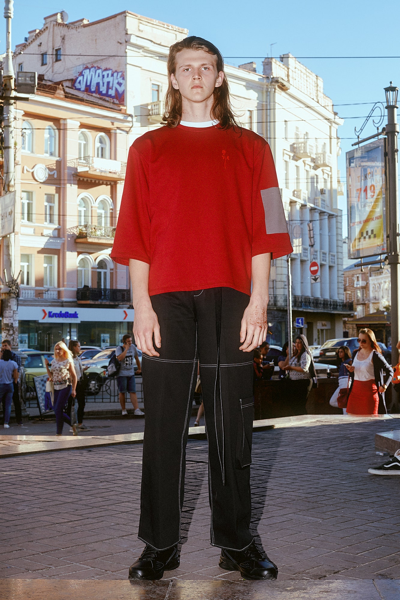 red relaxed top and black pants