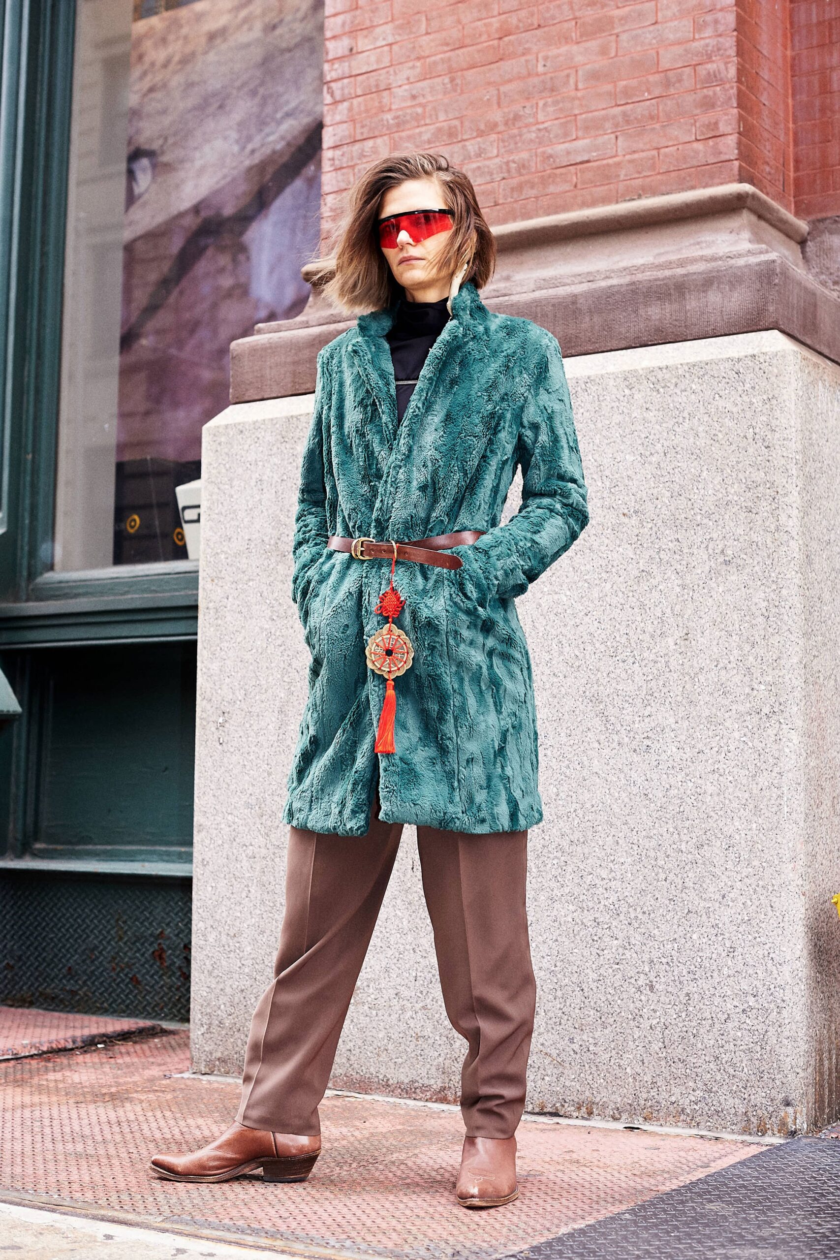 teal faux-fur coat with brown pants
