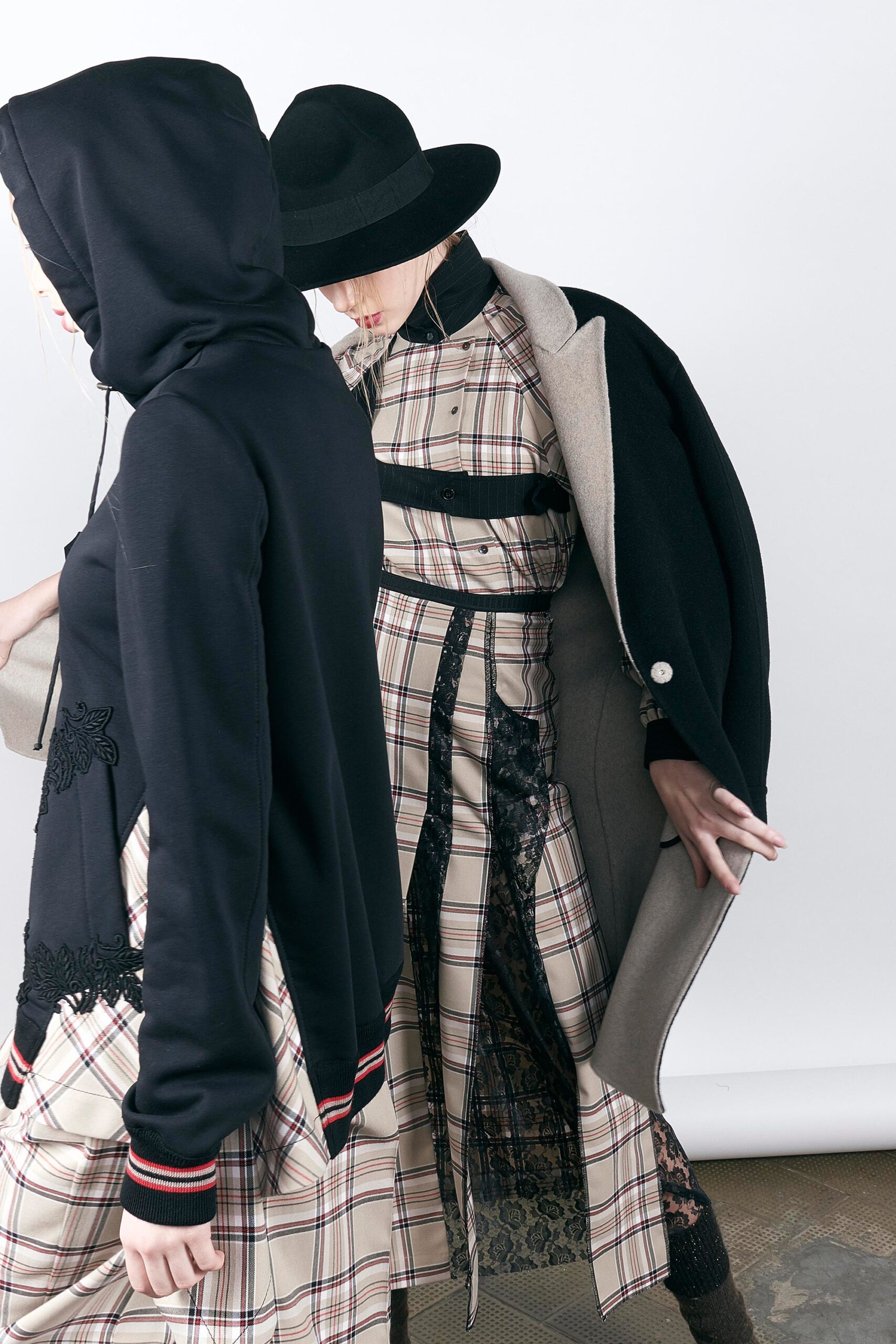 black coat, hoodie, beige plaid dress