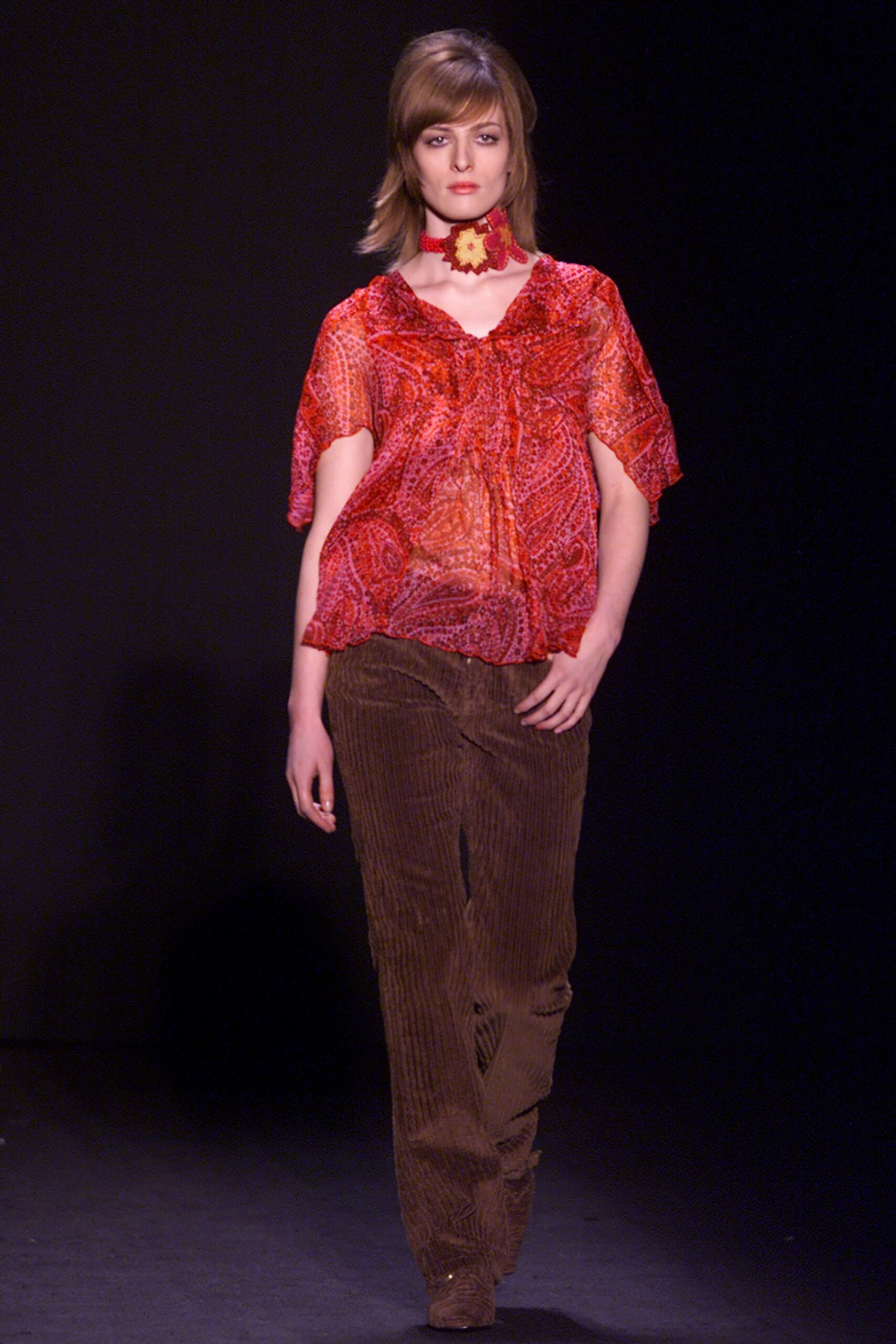 red printed top with brown pants