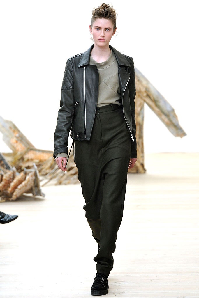 black leather fitted jacket with gray top and green tailored pants