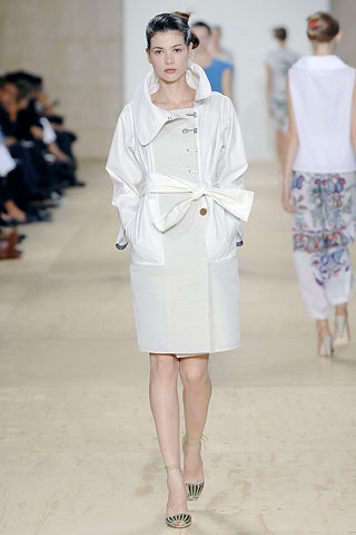 white relaxed coat and beige fitted dress