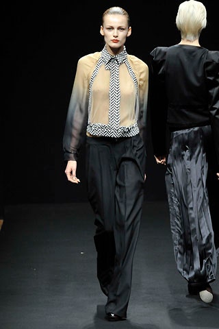 beige and black silk blouse with relaxed pants