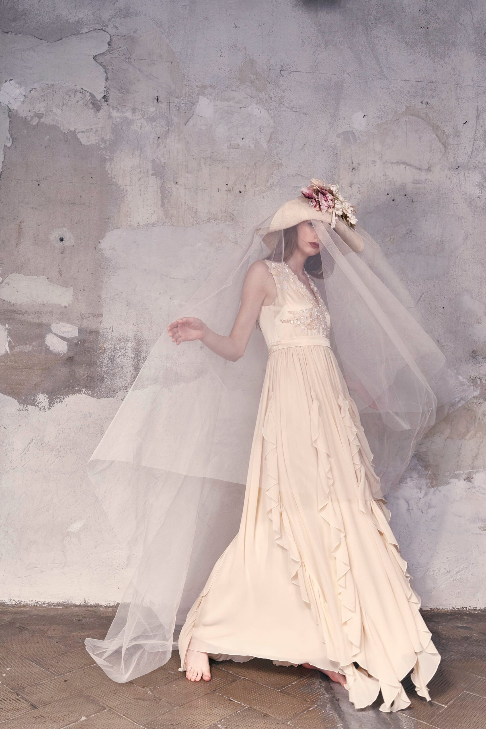 beige silk sleeveless v-neck fitted ruffled flowing gown