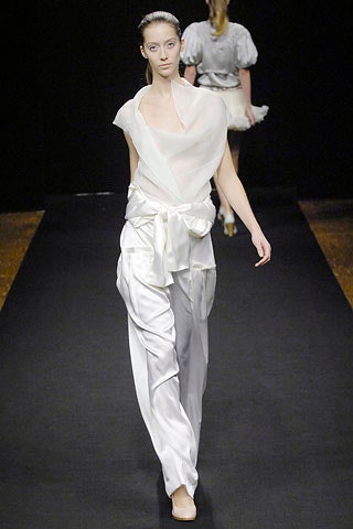 white silk draped top and fitted pants