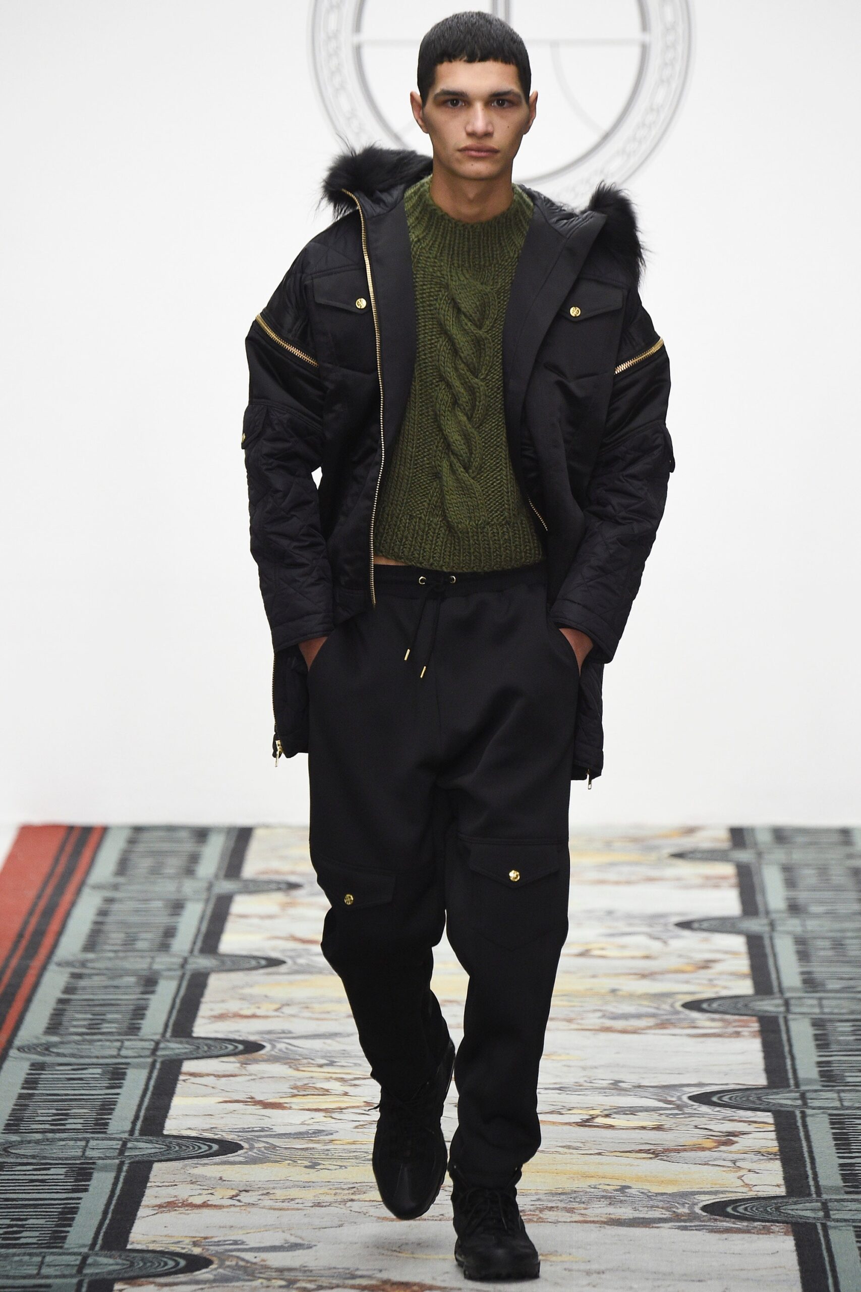 black jacket green sweater black pants