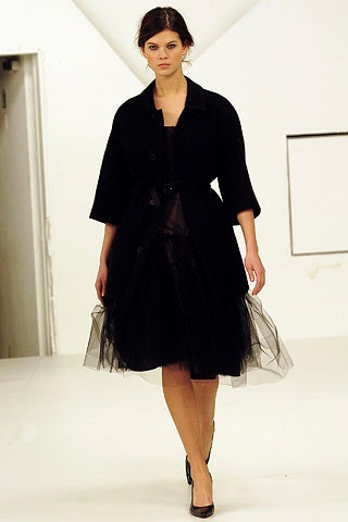 black wool coat and black tulle dress