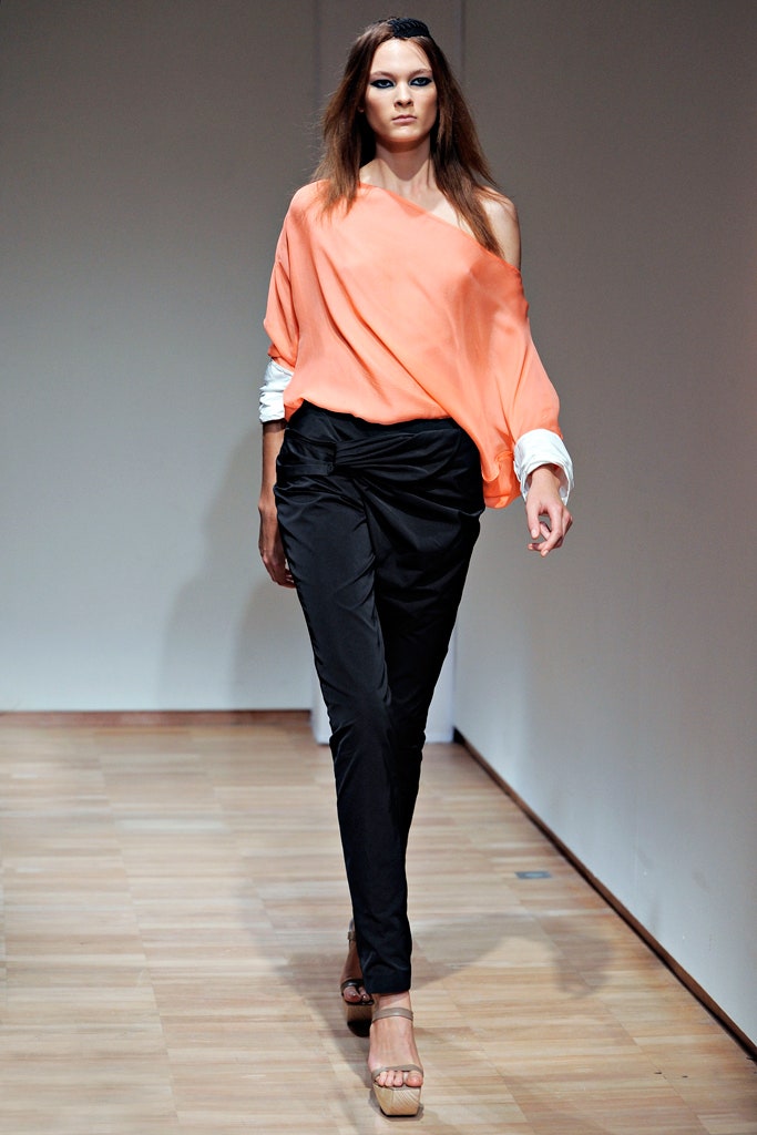 orange off-shoulder top with black pants