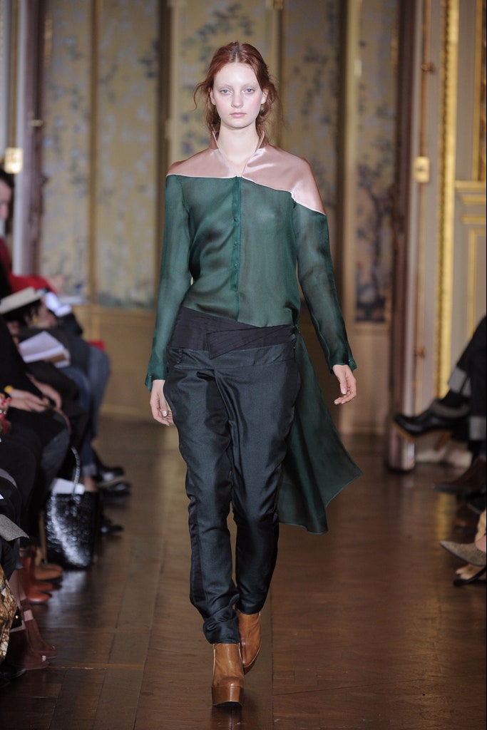 green silk off-shoulder shirt with black pants