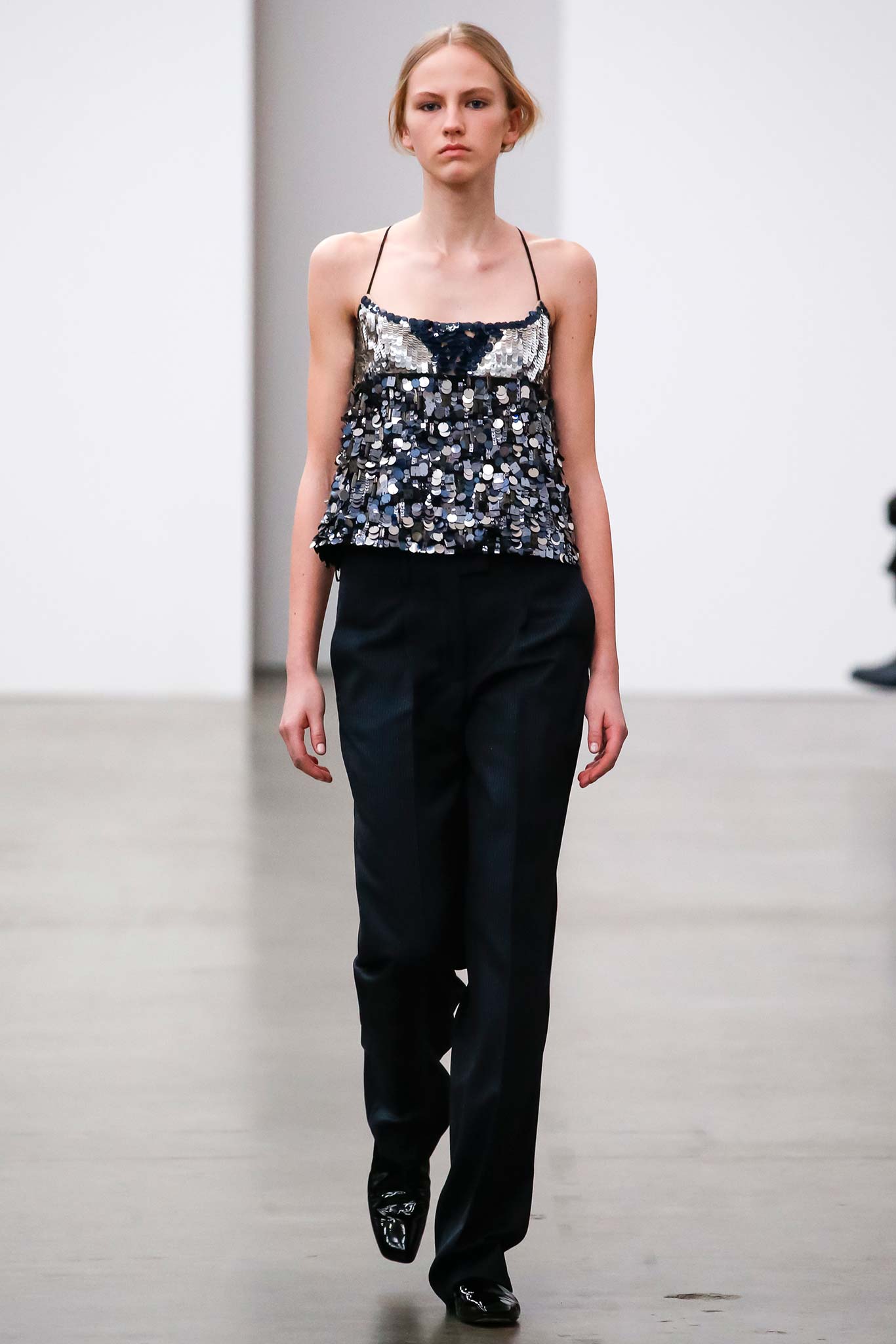 black sequined sleeveless top with tailored pants