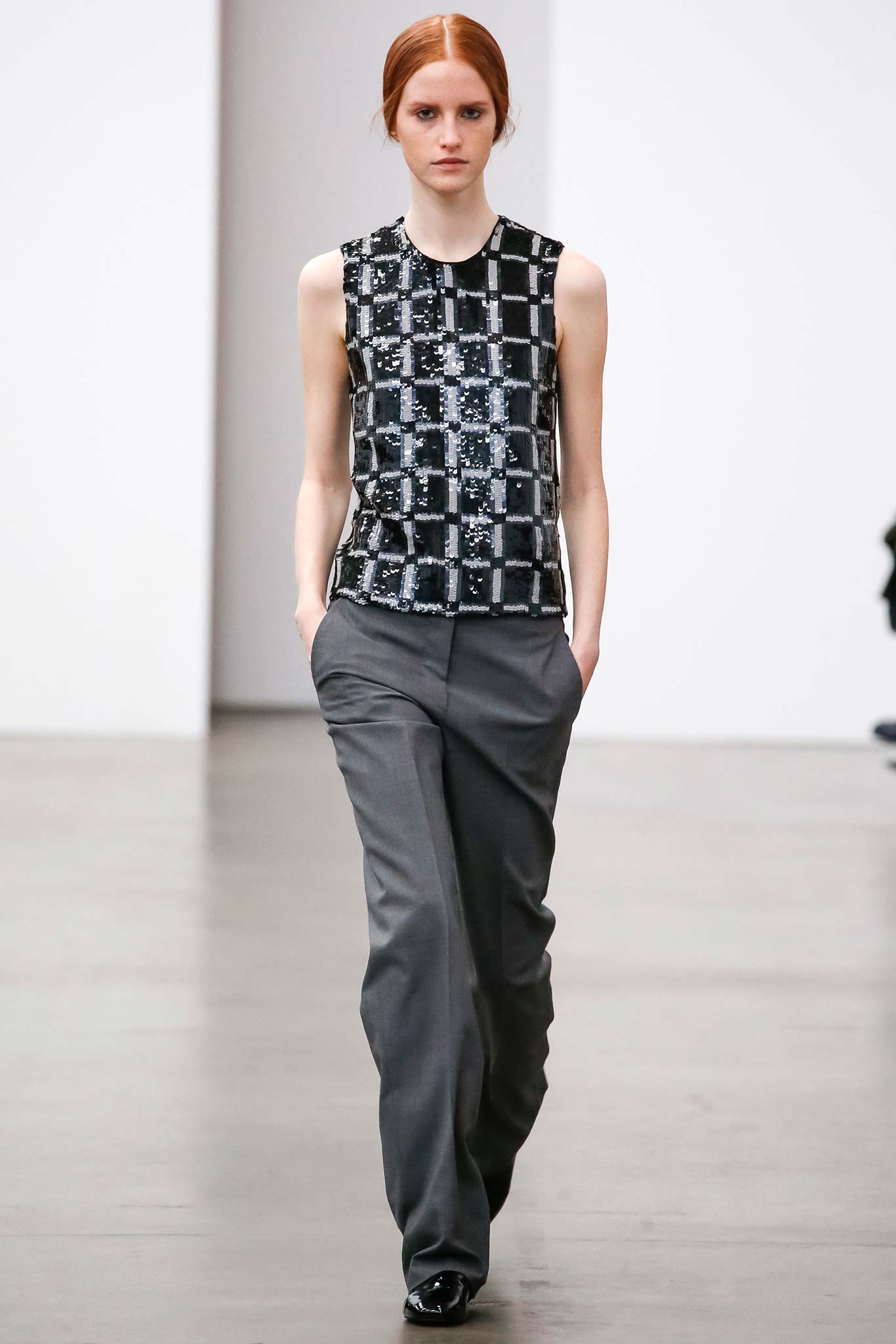 fitted black and white top with tailored gray pants