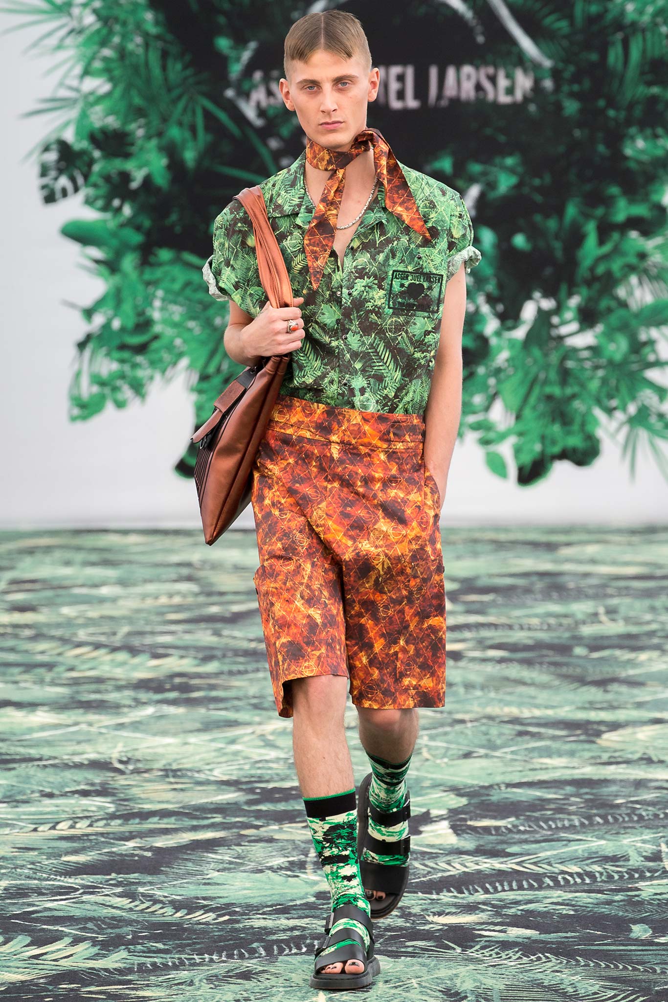 green printed shirt and orange shorts