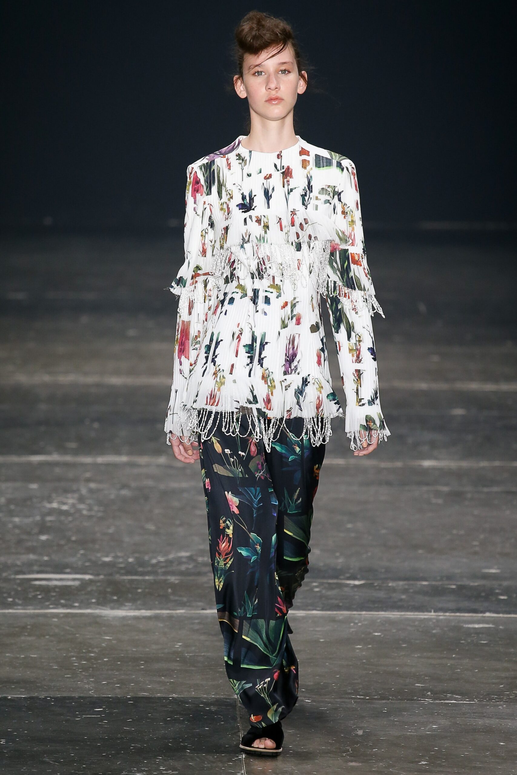 white embroidered top with fringes and black flared pants