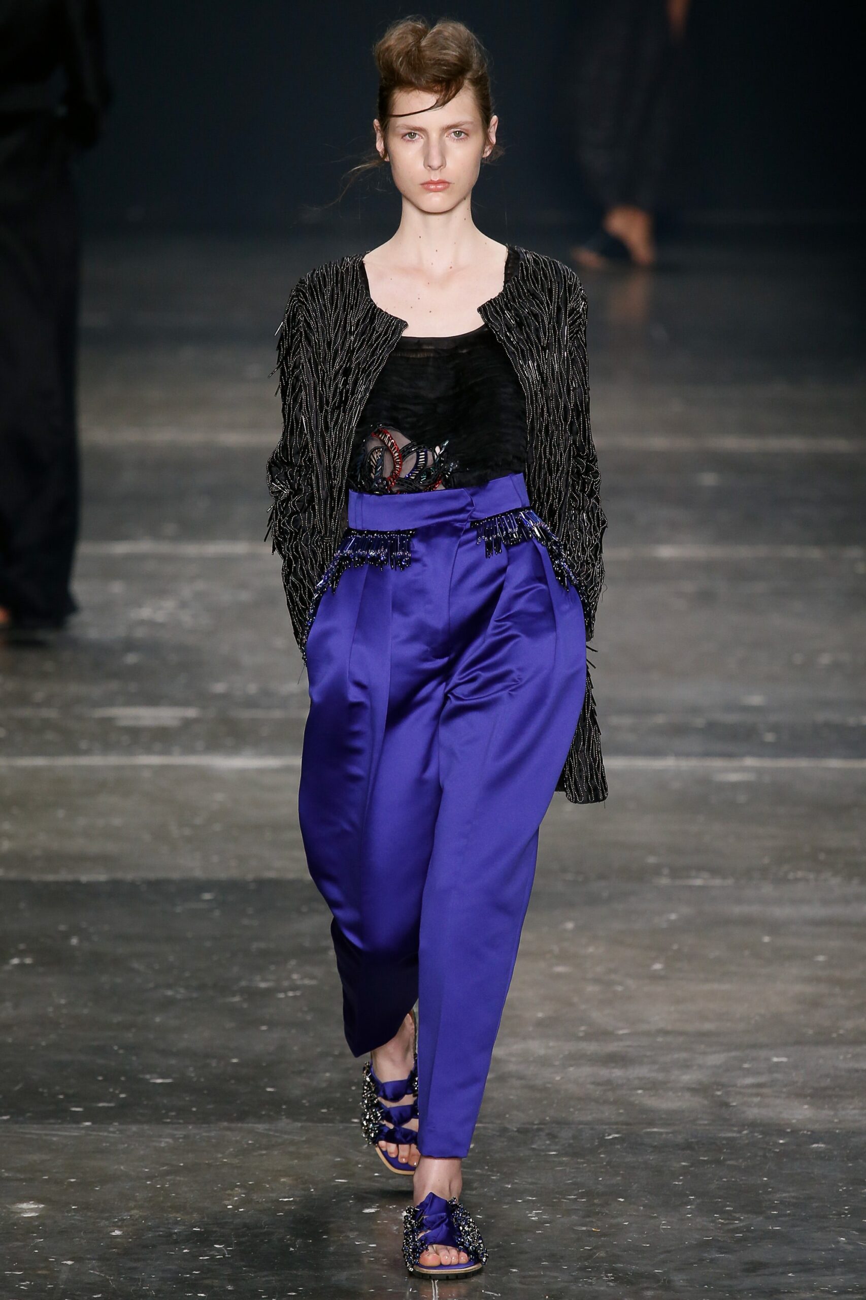 black silk sleeveless top with blue pants