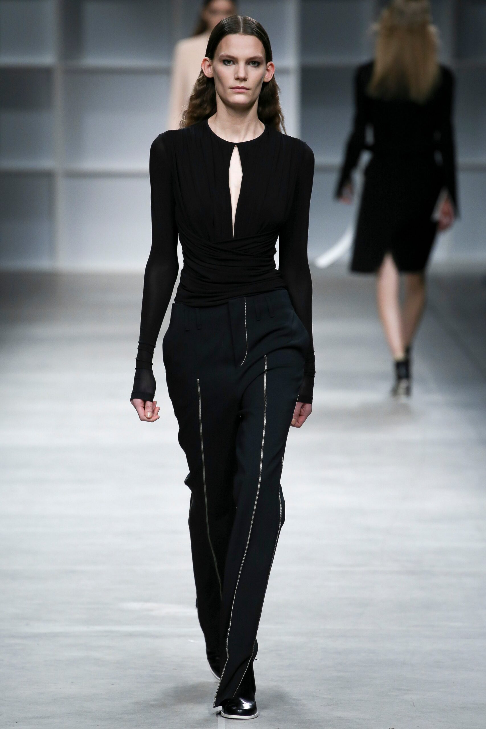 black fitted silk top and tailored pants